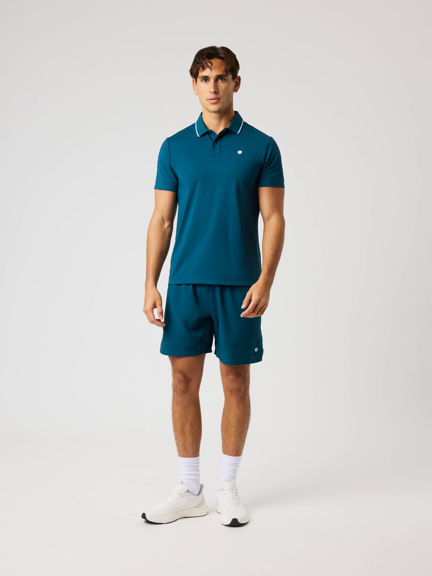 Full-body front view of a model wearing the Ace Polo Shirt in Reflecting Pond (Green) for premium tennis performance. - Image 3