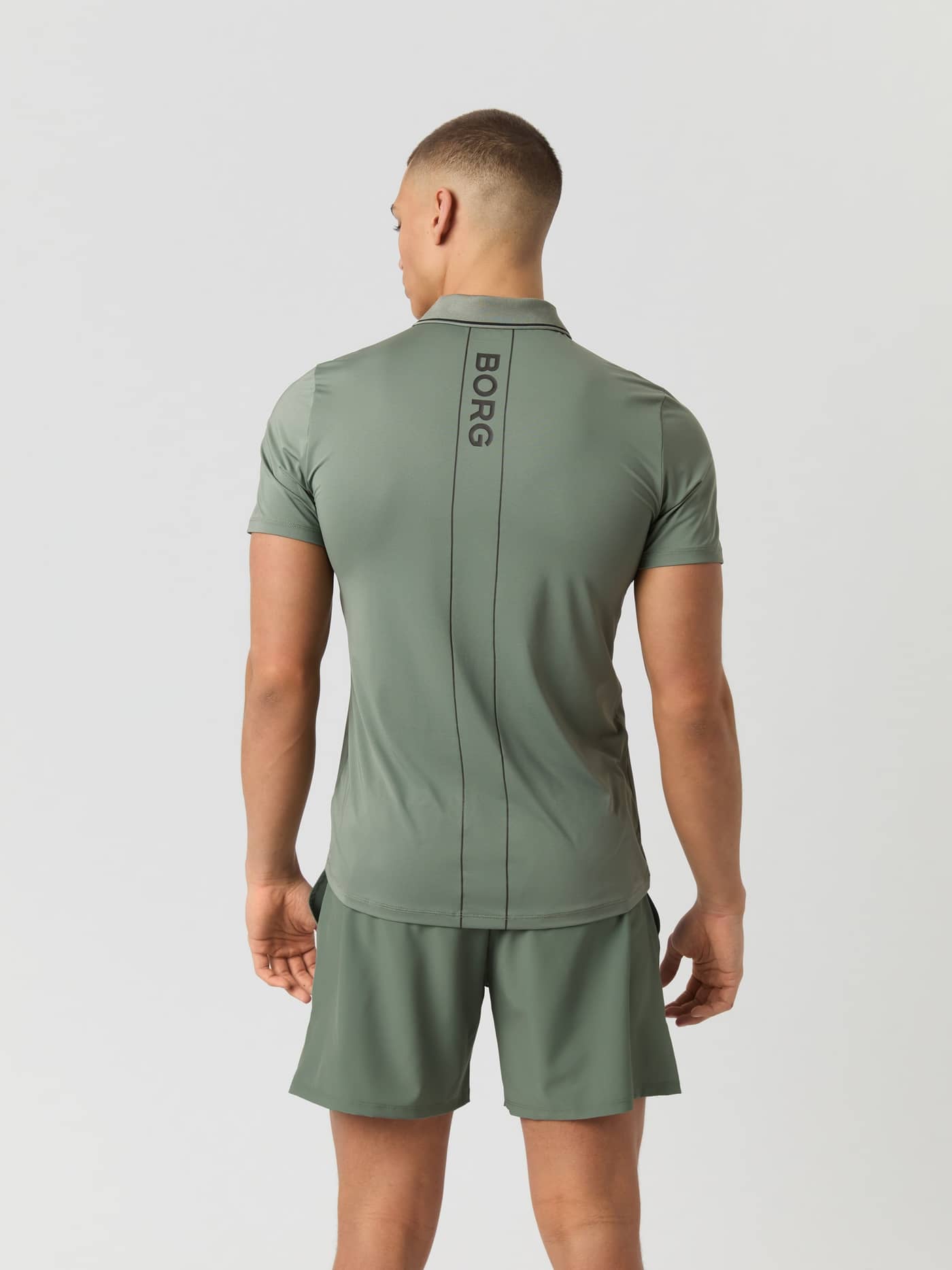 Back view of a model wearing the Björn Borg Ace Polo Shirt in Agave Green, showcasing the vertical BORG logo on the back. - Image 2