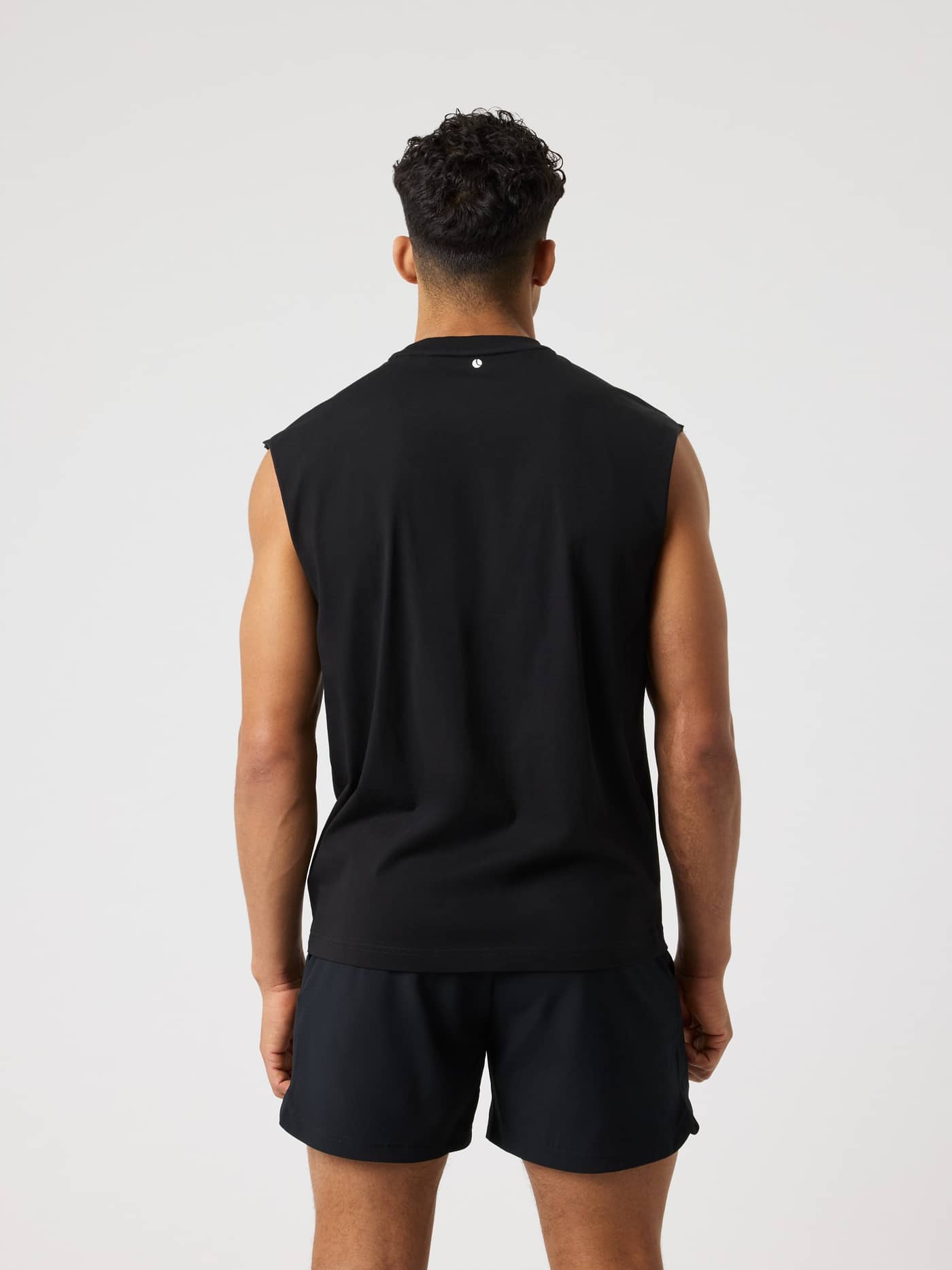 Back view of a man wearing the Black Beauty (Black) Borg Gym Sleeveless T-Shirt, a loose training top with a white logo. - Image 2