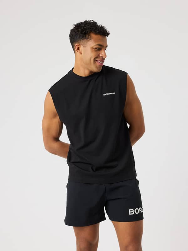 Front view of a man in the oversized Björn Borg Gym Sleeveless T-Shirt in Black Beauty (Black) with a white logo.