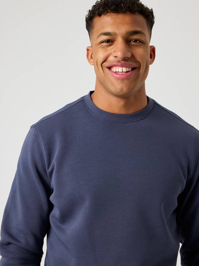 Front view close-up of a man wearing the regular fit Björn Borg Centre Sweatshirt in Odyssey Gray (blue). - Image 4