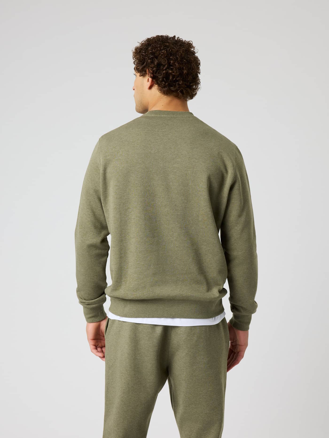 Back view of a man wearing the Björn Borg Centre Sweatshirt in Winter Moss Melange (Green) with a soft melange texture. - Image 2