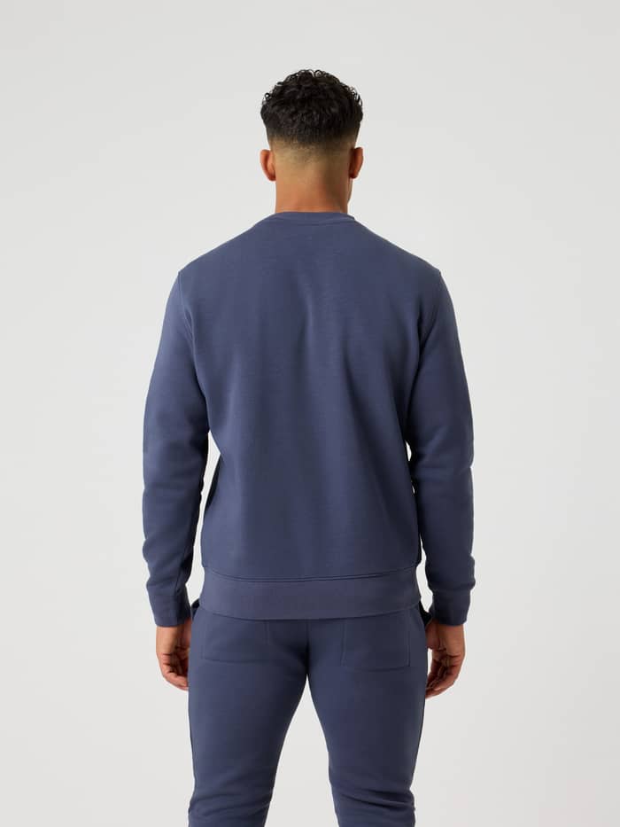 Back view of a man wearing the Björn Borg Centre Sweatshirt in Odyssey Gray (Blue) with a regular fit. - Image 2