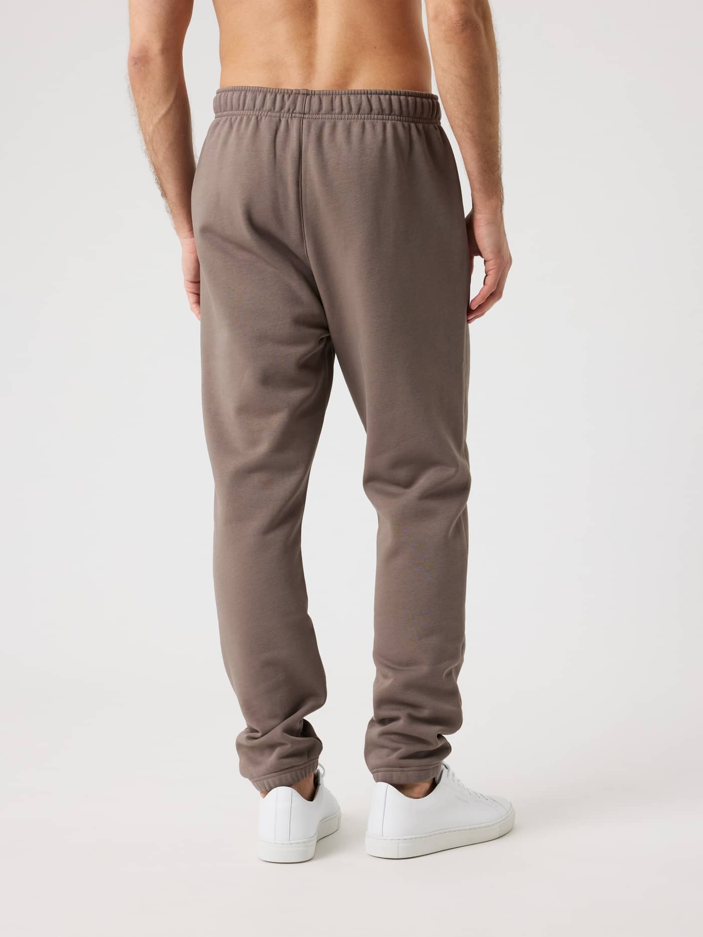 Back view of a man wearing the Björn Borg Centre Sweatpants in Falcon (Brown) with a functional regular fit. - Image 2