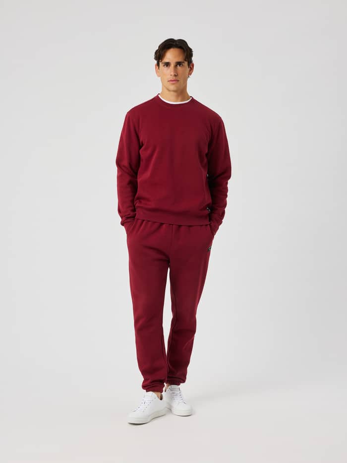 Centre Sweatpants in Cabernet (Red) worn by a model in a studio setting.
