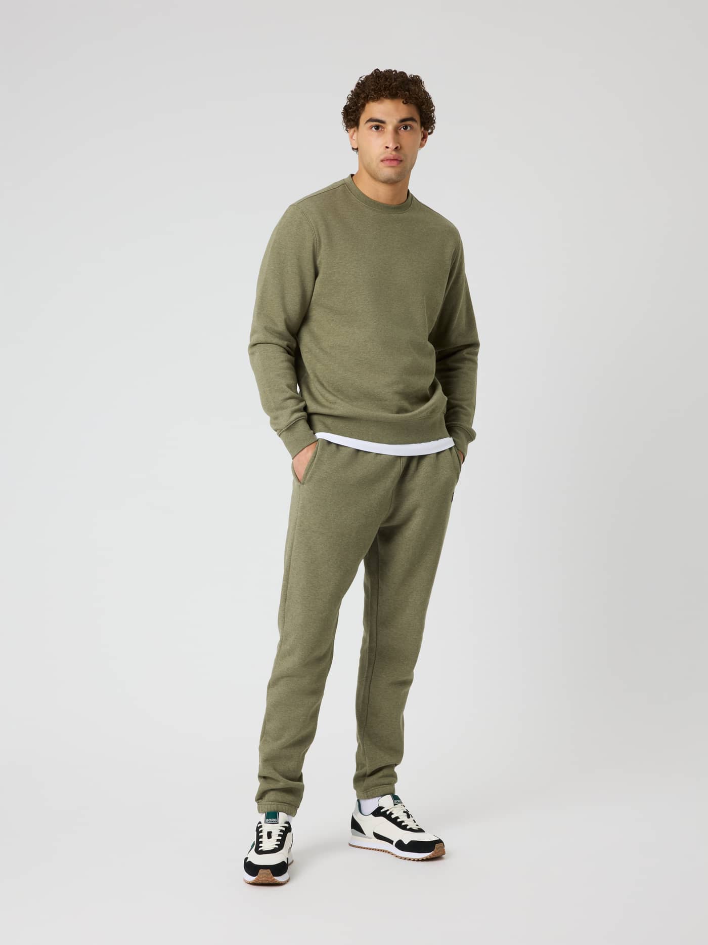 Full-body front view of a man wearing Centre Sweatpants in Winter Moss Melange (Green) with a soft melange texture. - Image 3