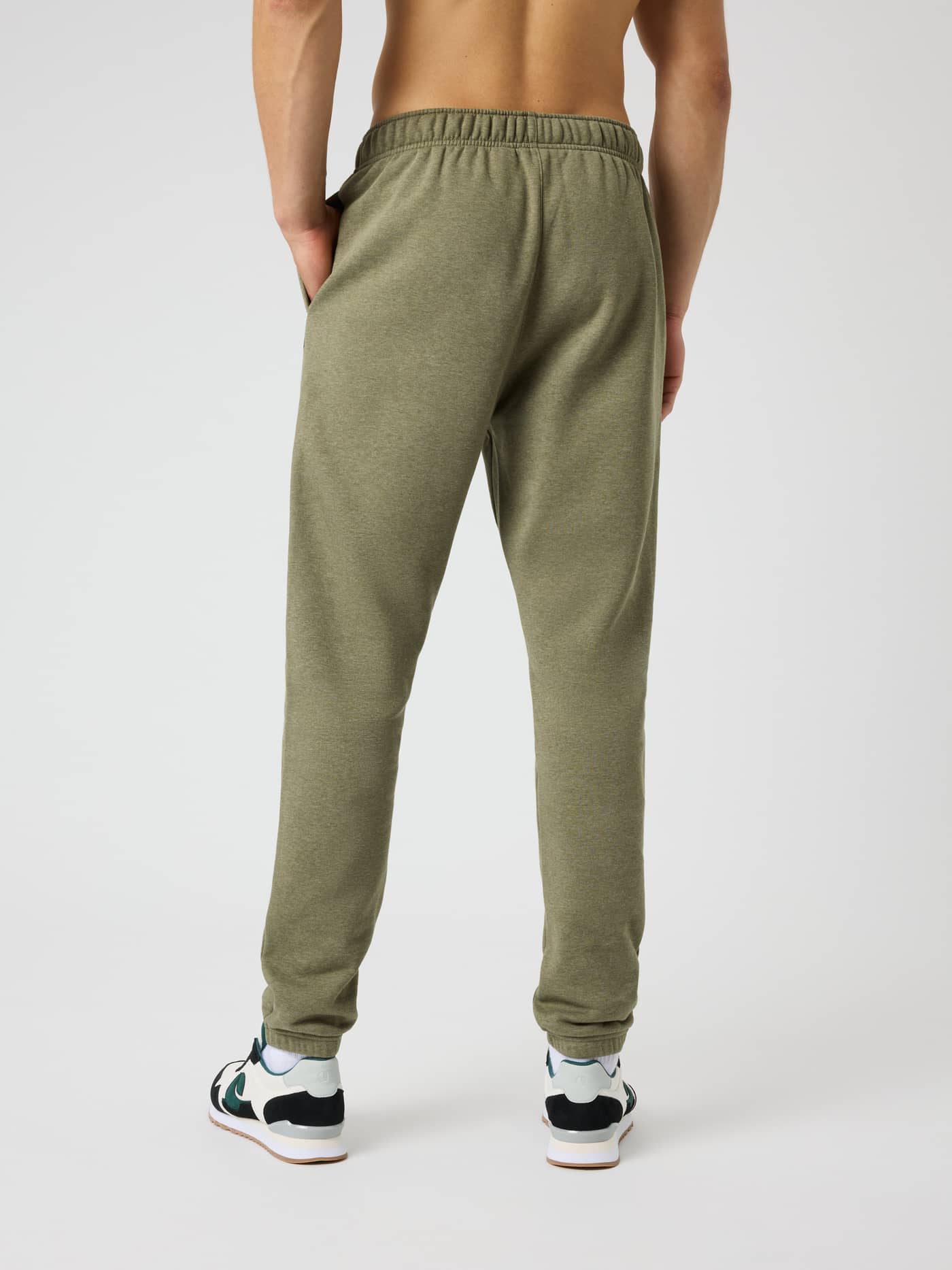 Back view of a man wearing Björn Borg Centre Sweatpants in Winter Moss Melange (Green) with melange pattern and regular fit. - Image 2