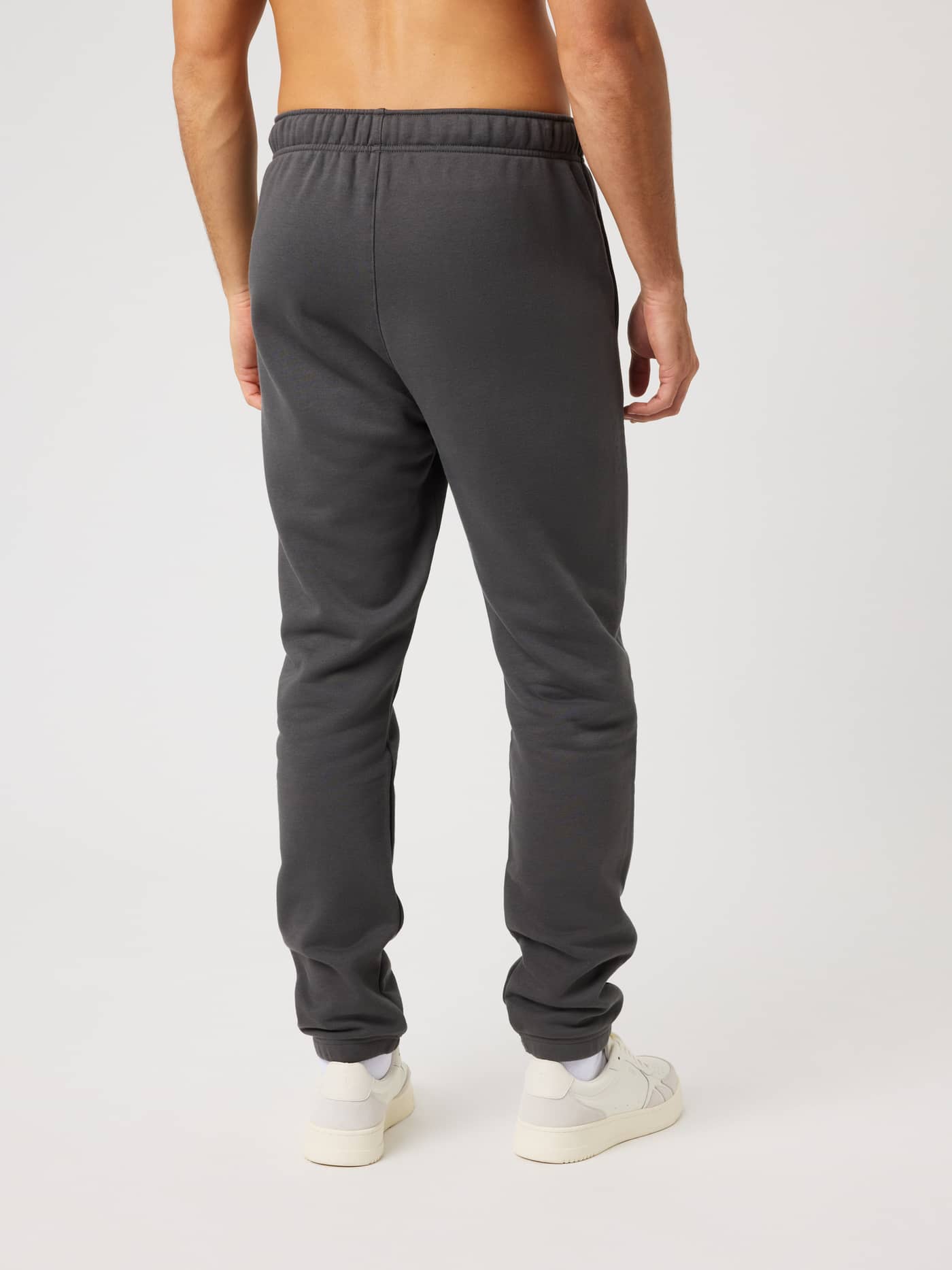 Back view of a model wearing Björn Borg Centre Sweatpants in Asphalt (Black) with a relaxed fit and elastic cuffs. - Image 2