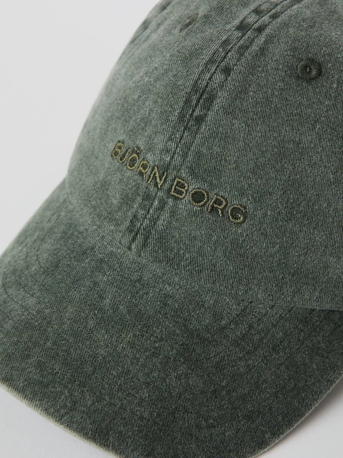 Close-up of the Thyme (Green) Borg Washed Cap, showing the embroidered logo and washed-out organic cotton texture. - Image 3