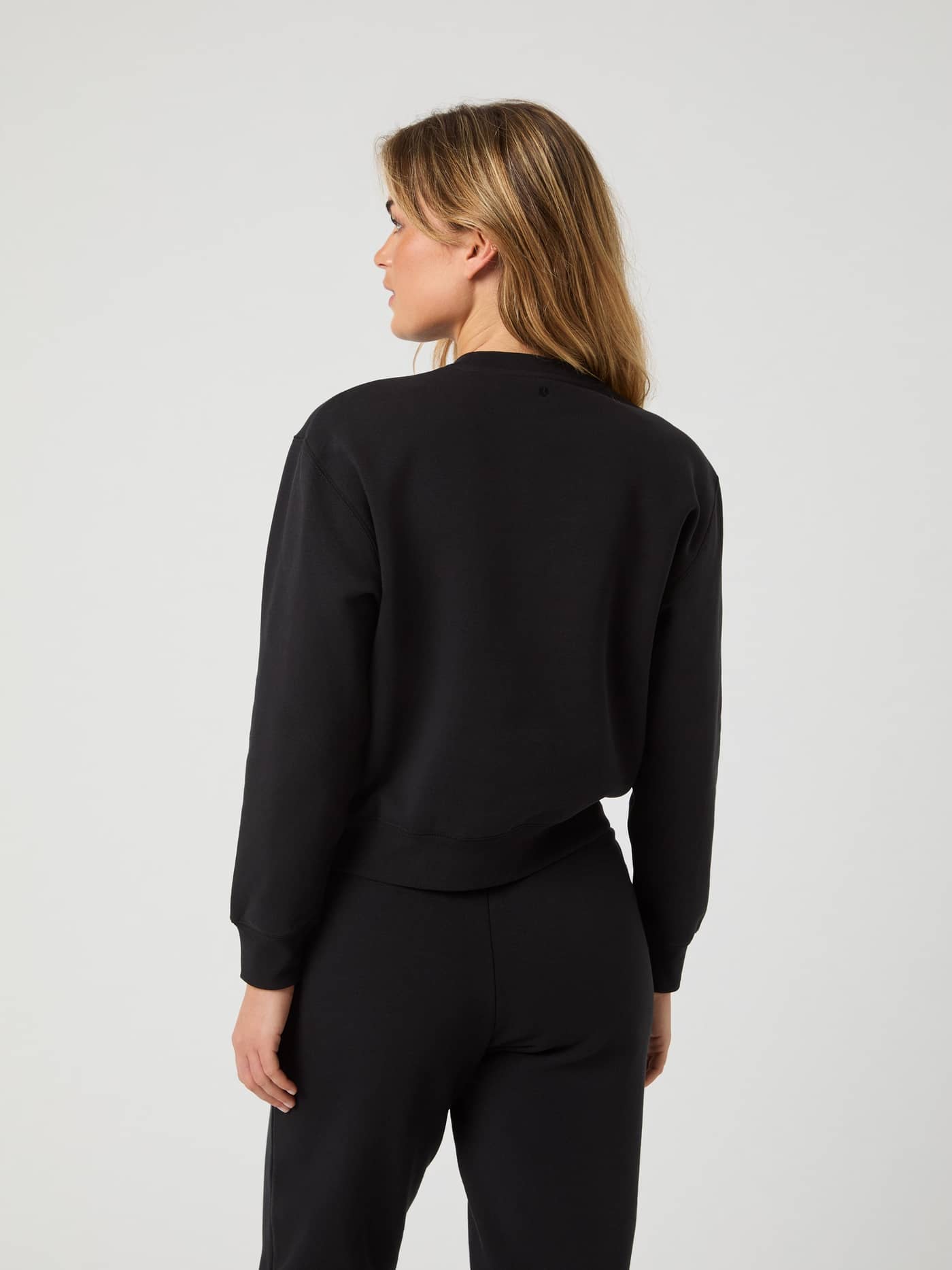 Back view of a model in the Björn Borg Centre Sweatshirt in Black Beauty (Black), featuring a soft feel and relaxed fit. - Image 2