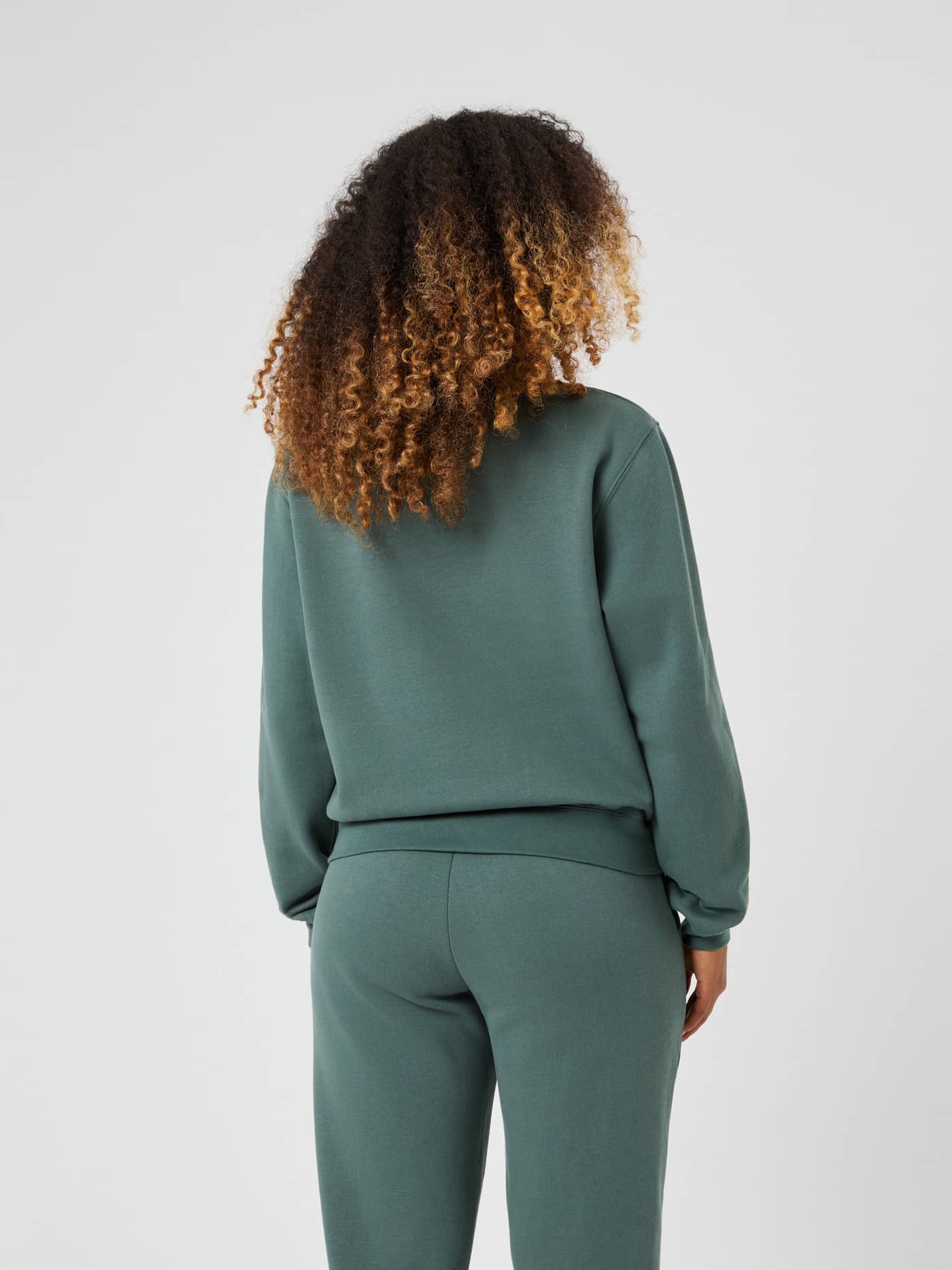Back view of a woman wearing the Björn Borg Centre Sweatshirt in Balsam Green (Green) for a stylish and regular fit. - Image 3
