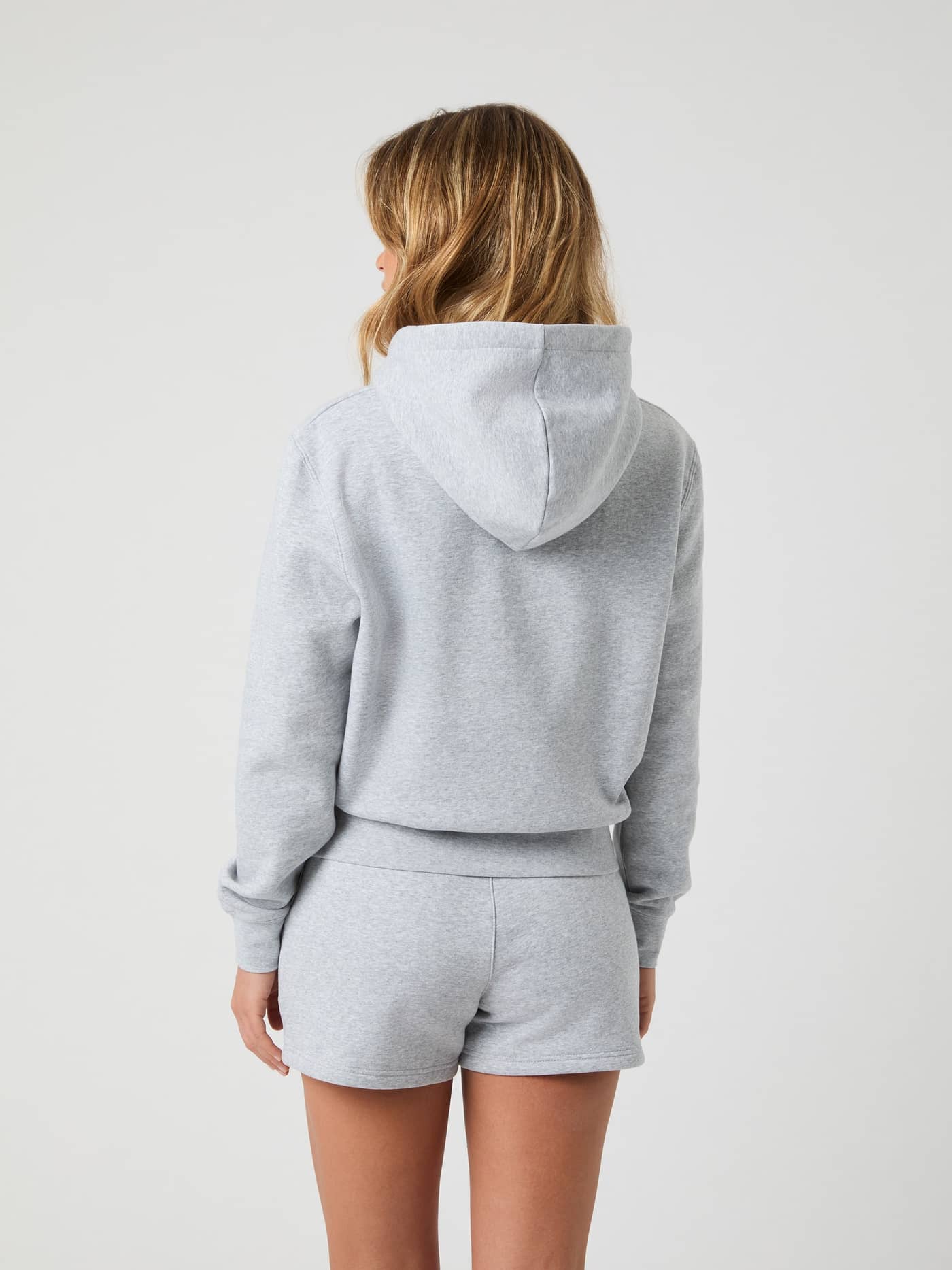 Back view of a model wearing the oversized Björn Borg Centre Hoodie in Light Grey Melange (Grey). - Image 2