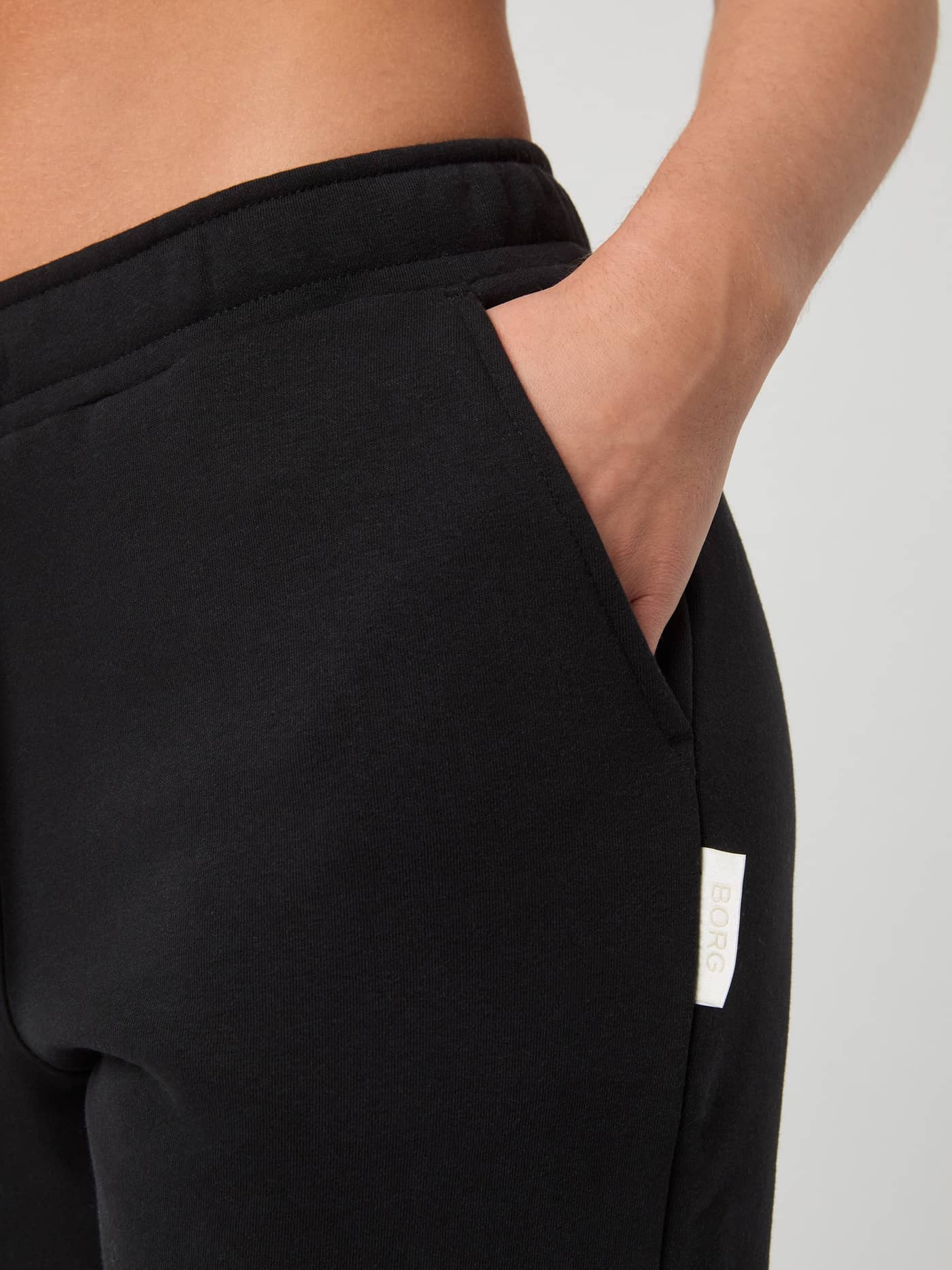 Detailed close-up of the Björn Borg Centre Sweatpants in Black Beauty (Black), highlighting the side pocket and white logo. - Image 4
