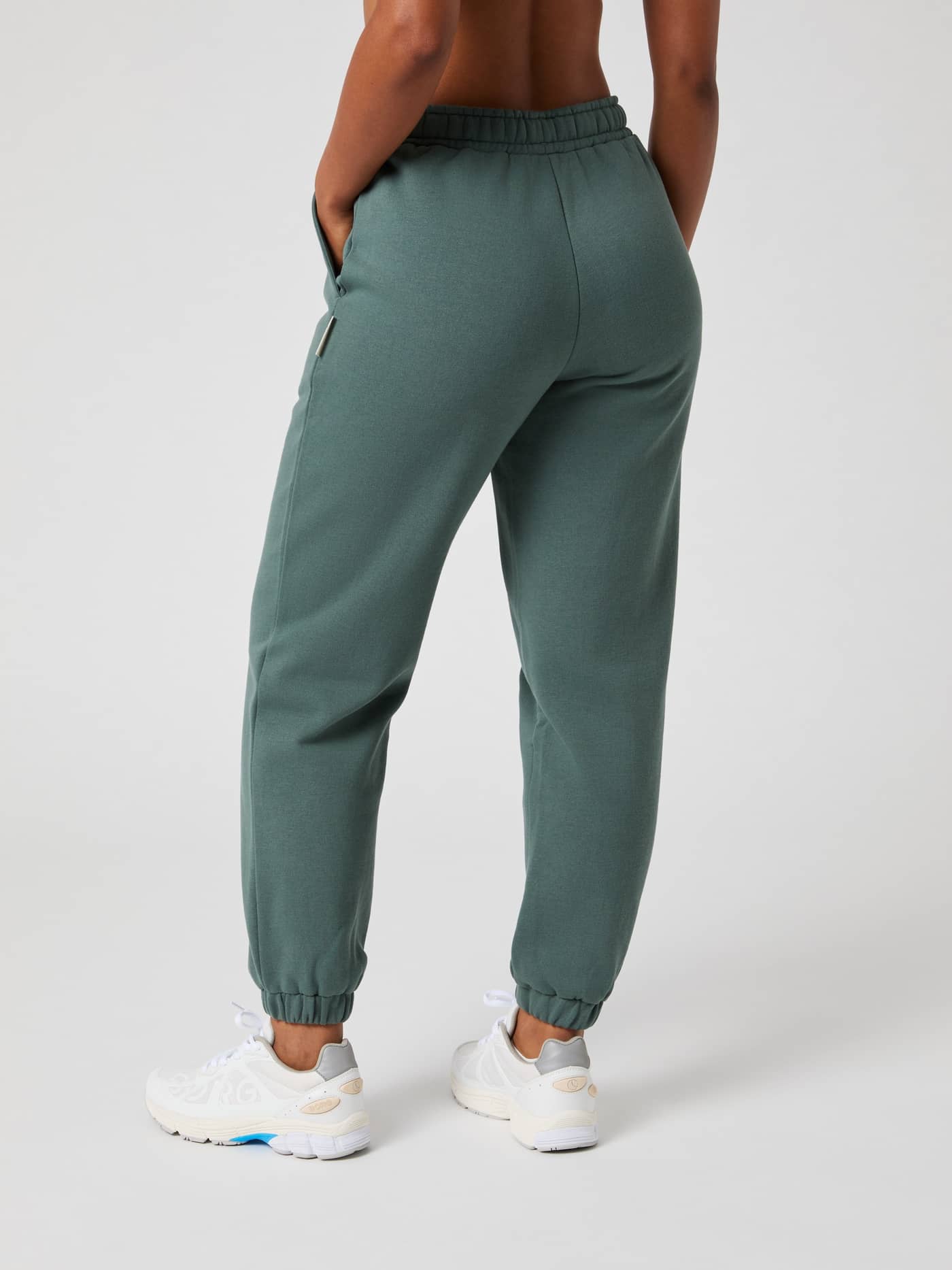 Back view of a model wearing the soft fleece Björn Borg Centre Sweatpants in Balsam Green (Green) with a regular fit. - Image 3