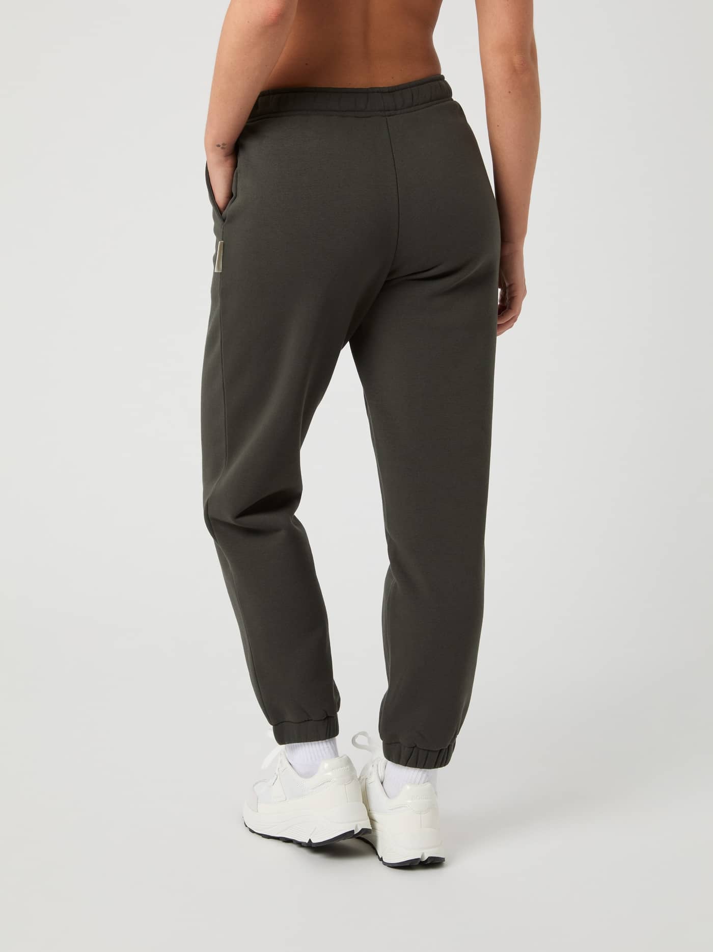 Back view of a model wearing the Björn Borg Centre Sweatpants in Peat (Green), featuring a stylish fit and soft fleece. - Image 3