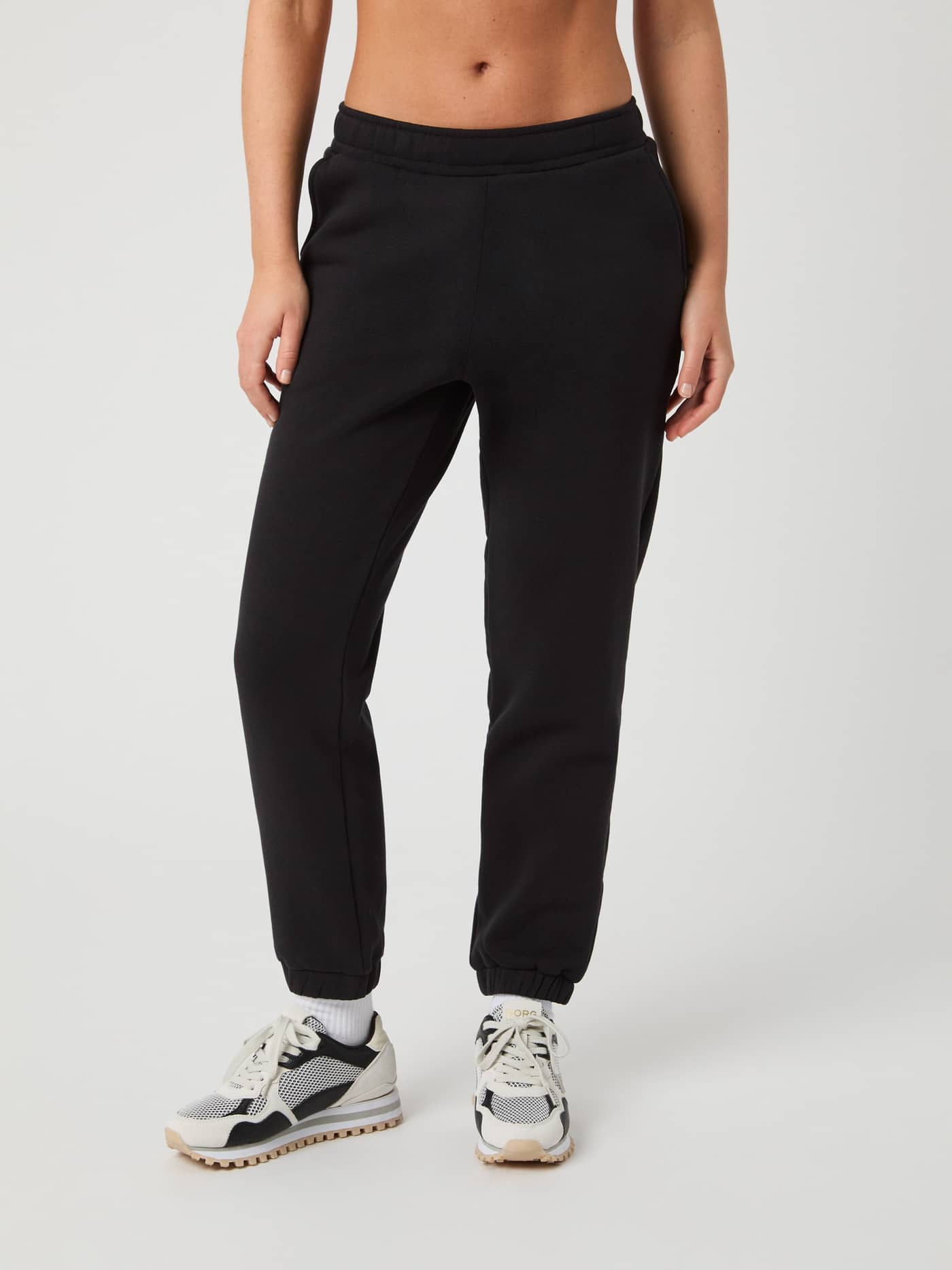 Front view of a model wearing the soft women's Björn Borg Centre Sweatpants in Black Beauty (Black), with a stylish fit. - Image 2