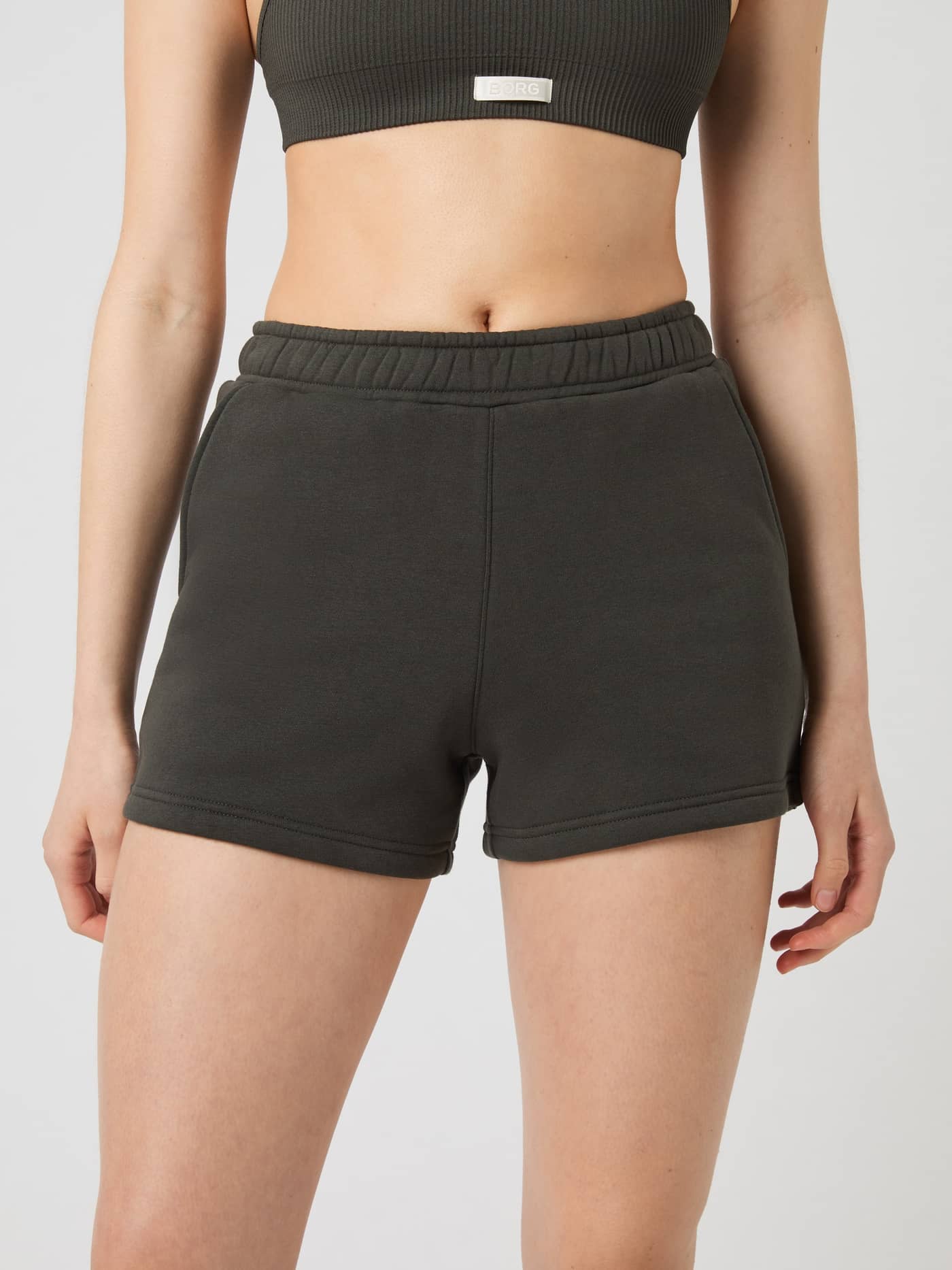 Front view of a model wearing the Björn Borg Centre Sweatshorts in Peat (Green) with a soft fleece and regular fit. - Image 2