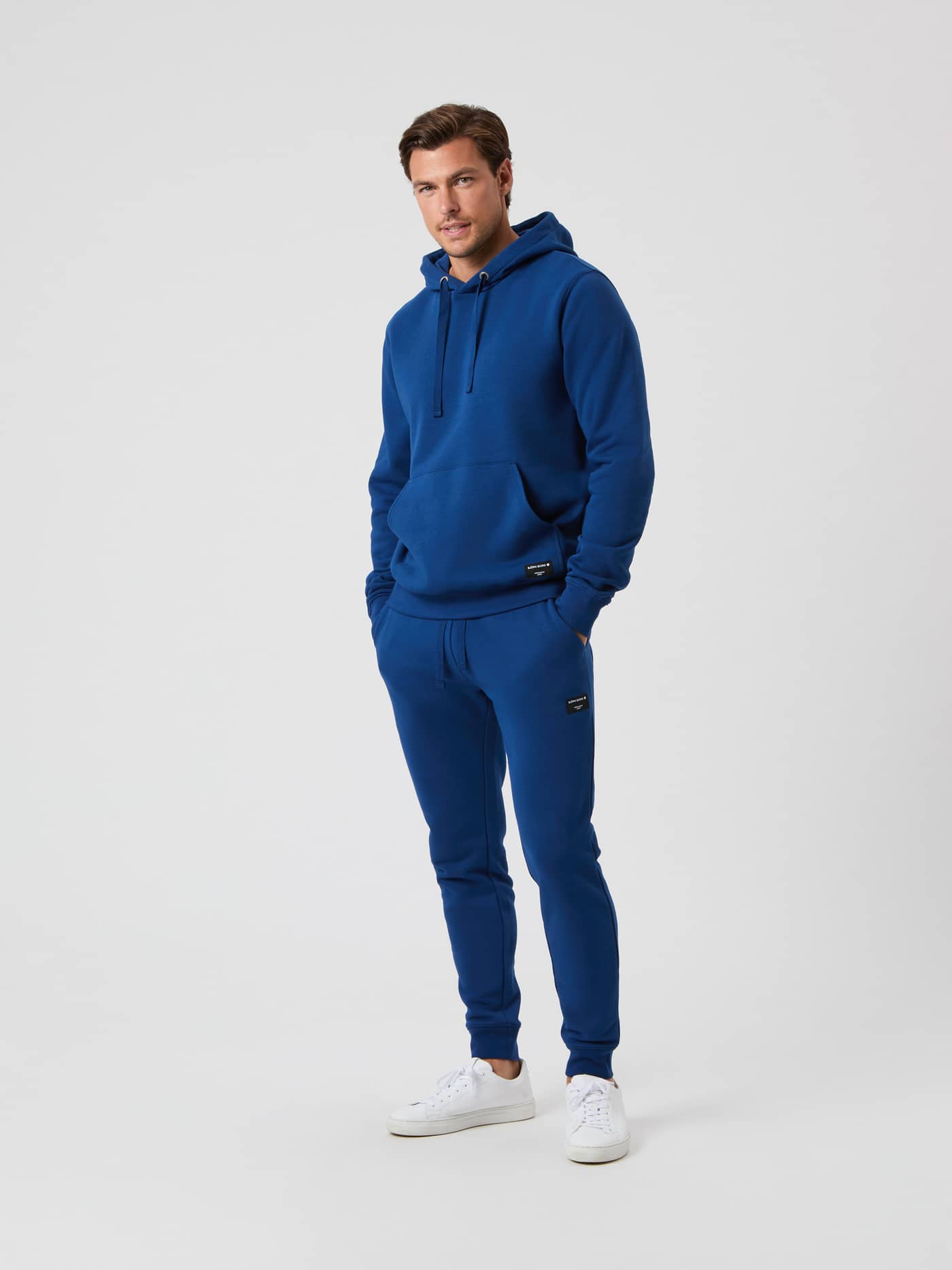 Full body shot of a model wearing the Björn Borg Centre Hoodie and matching sweatpants in Estate Blue. - Image 4