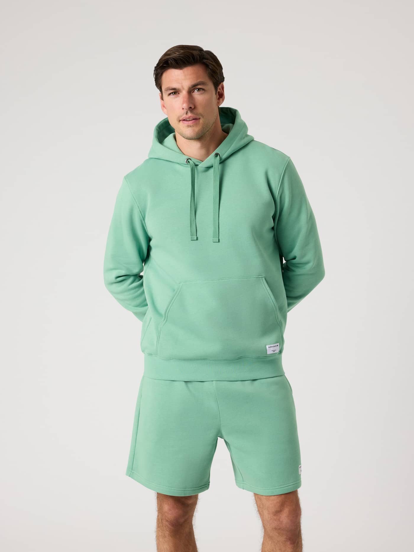 Vorderansicht eines Mannes im Björn Borg Centre Hoodie in Malachite Green (Grün), kombiniert mit passenden Shorts. - Image 2
