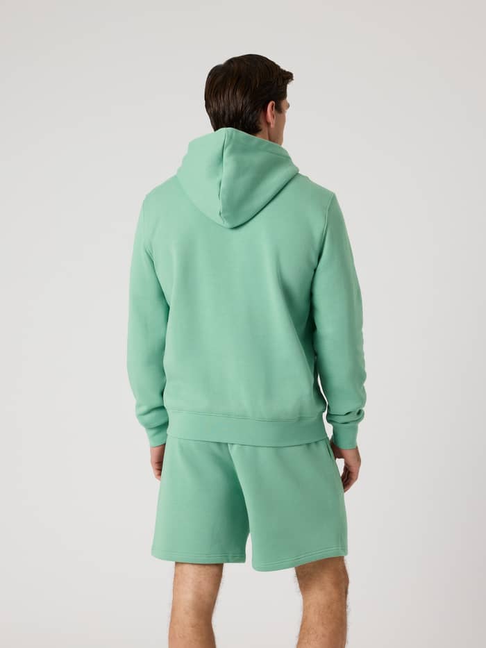 Back view of a man wearing the Björn Borg Centre Hoodie in Malachite Green (Green) paired with matching shorts. - Image 3