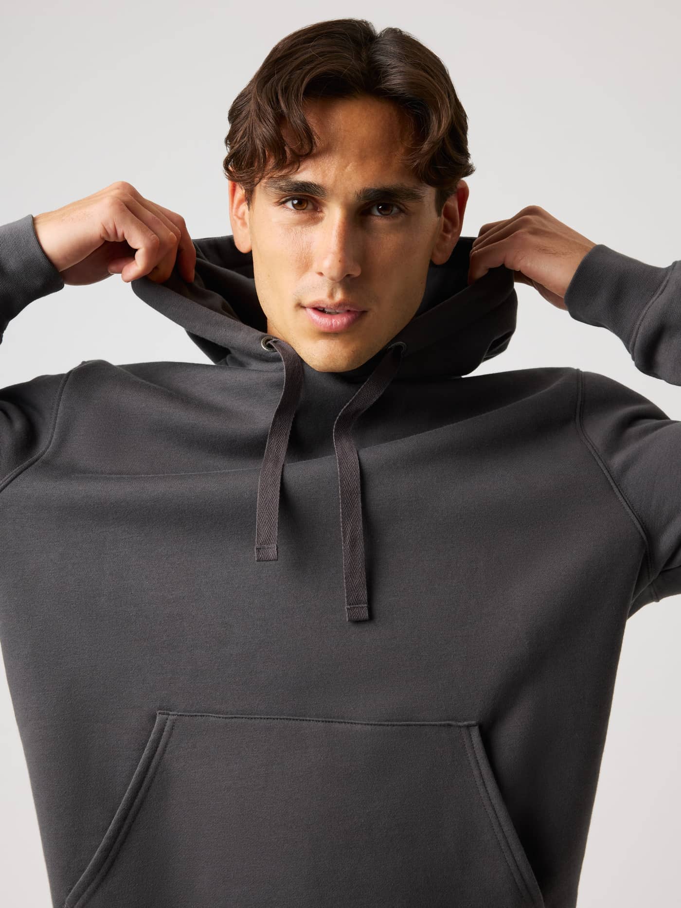 Centre Hoodie in Asphalt (Grey) on a model, featuring a double layer hood, drawstrings, and a kangaroo pocket. - Image 5