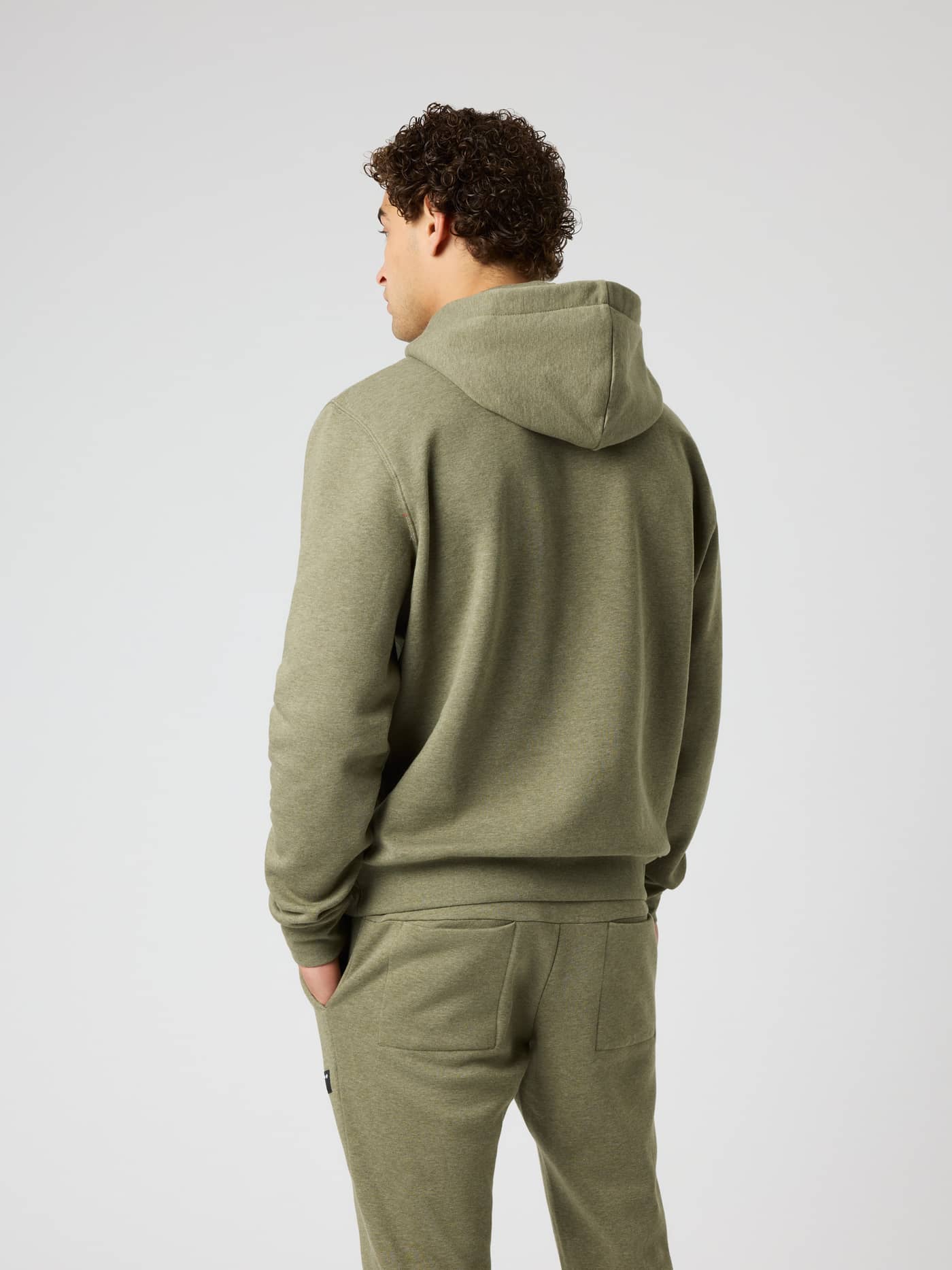 Back view of a man wearing the Björn Borg Centre Hoodie in Winter Moss Melange (Green) in a soft cotton and polyester blend. - Image 2