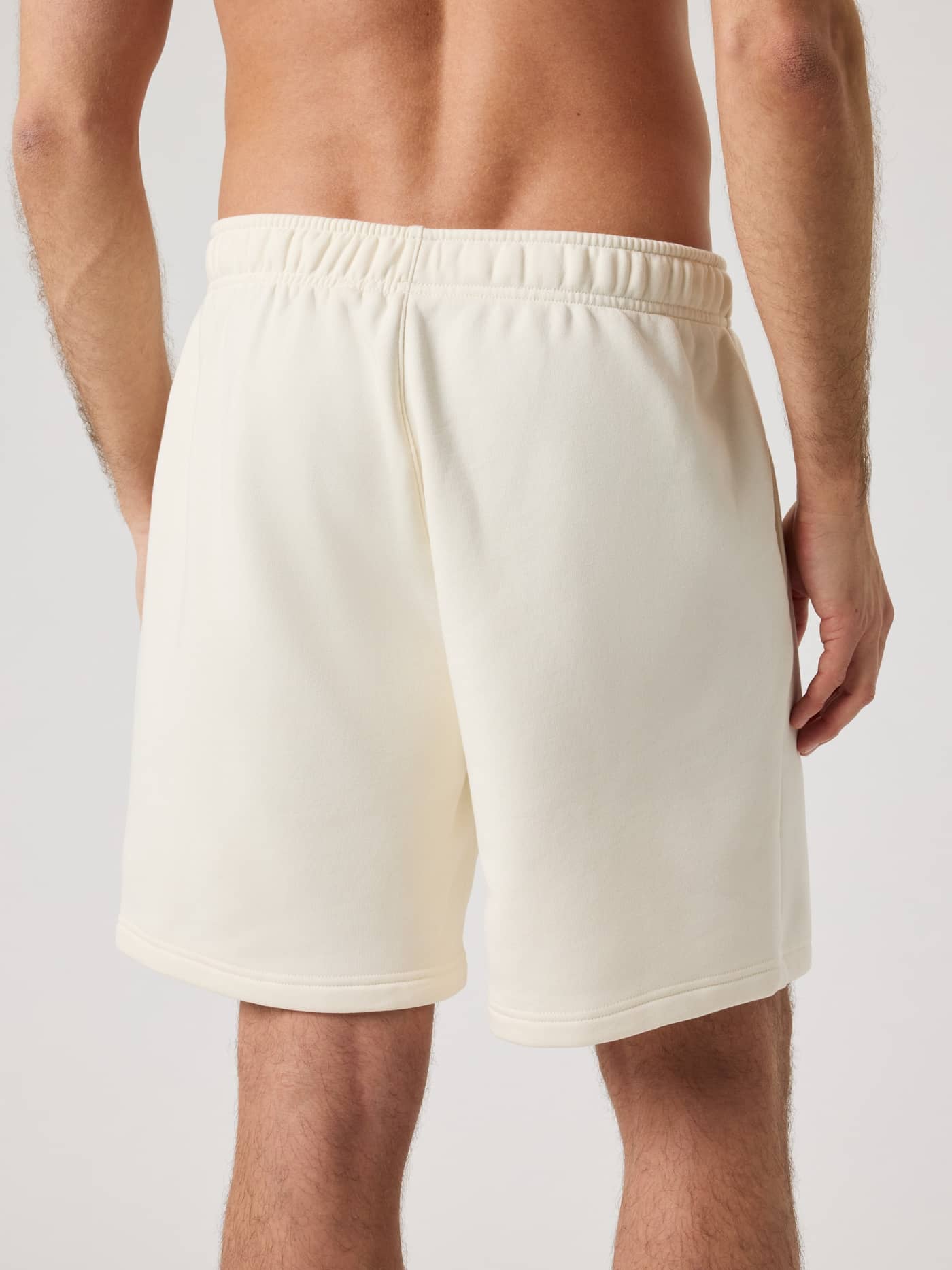 Back view of a man wearing the Björn Borg Centre Sweatshorts in Tofu (White) for a stylish and functional cotton-blend fit. - Image 2