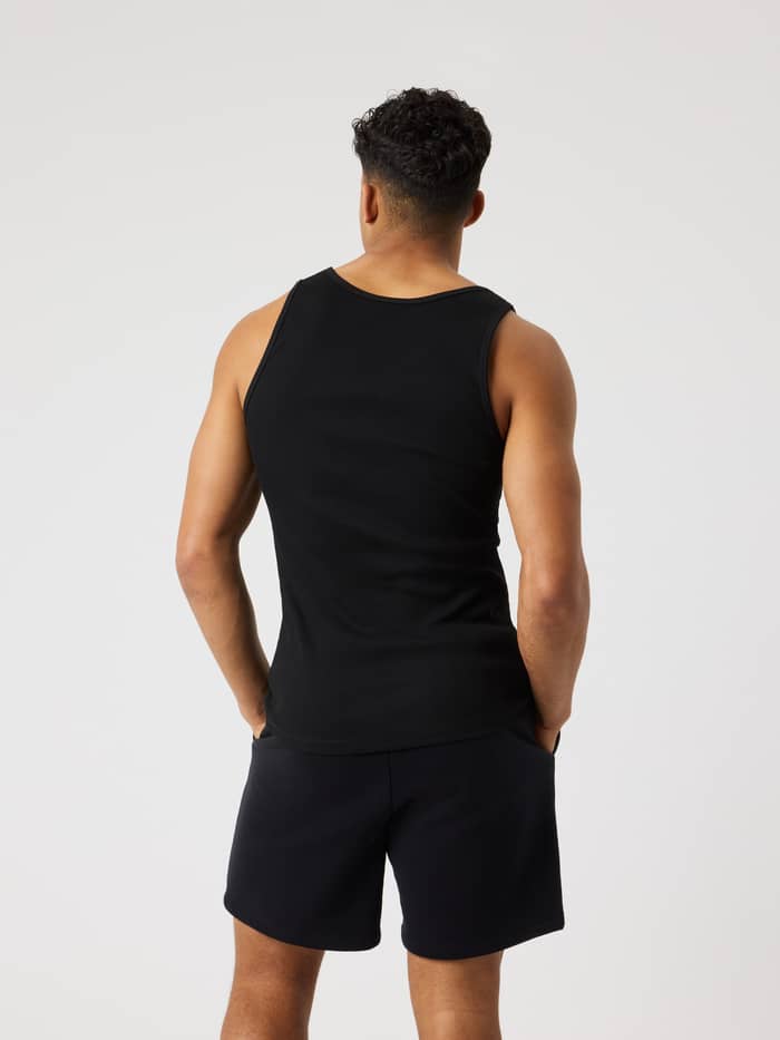 Back view of a man wearing the slim fit Björn Borg Centre Ribbed Tank in Black Beauty (Black) with a soft ribbed texture. - Image 2