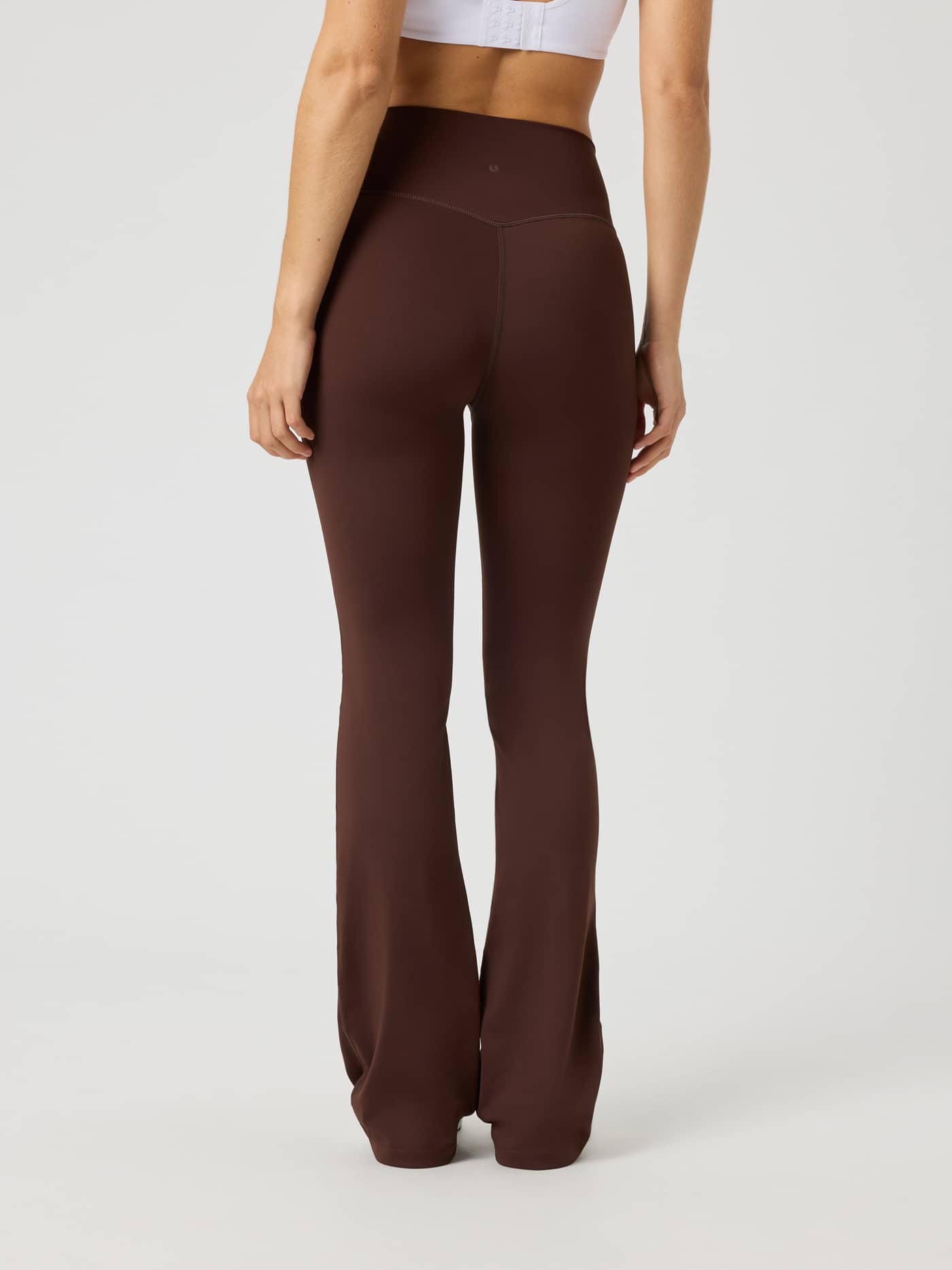 Back view of a model wearing Borg Flare Tights Tall in Coffee Bean (Brown) for a functional training fit. - Image 2