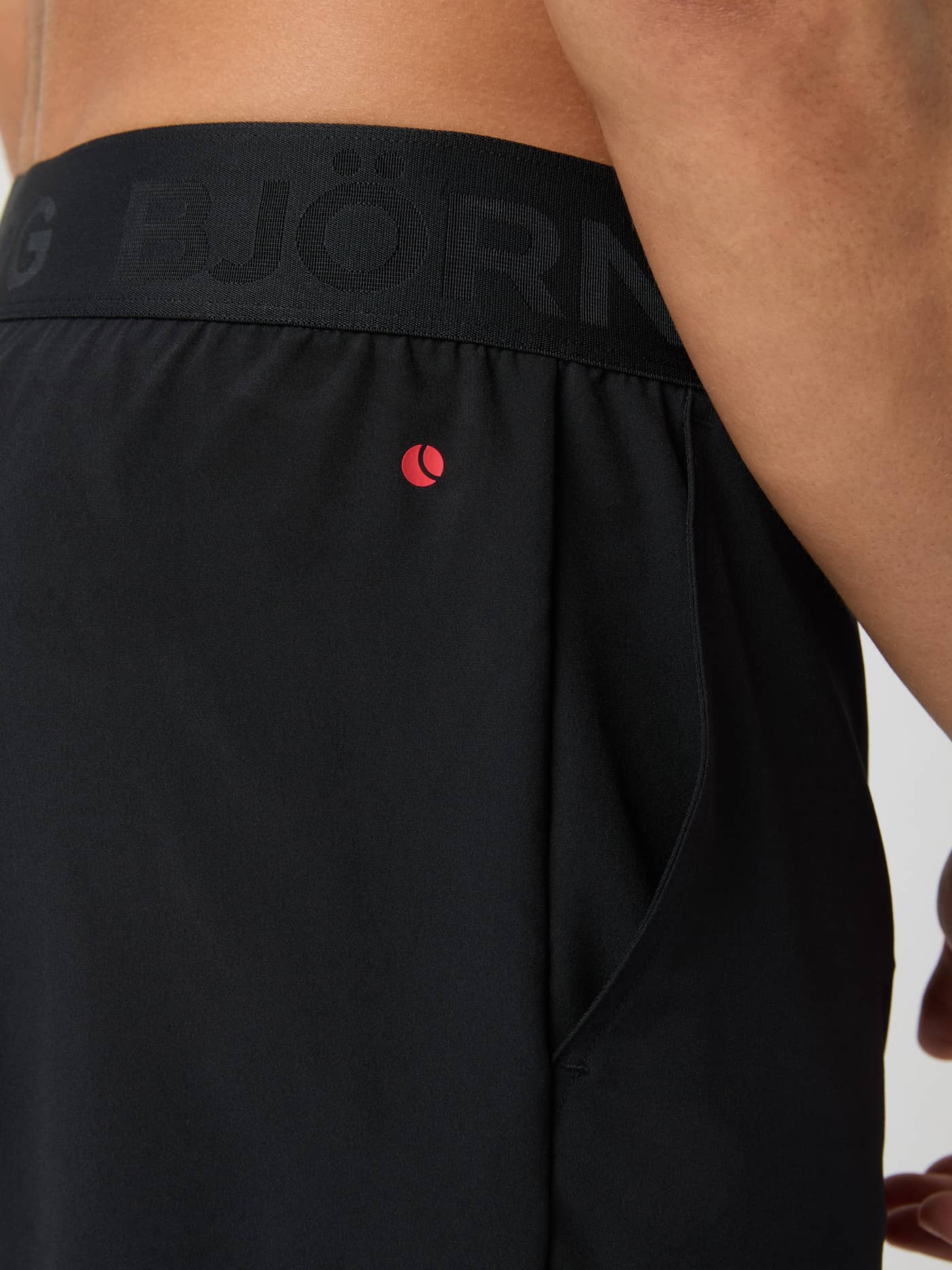 Close-up of Borg 2 In 1 Shorts in Black Beauty (Black) for training, featuring a branded waistband and red tennis logo. - Image 5