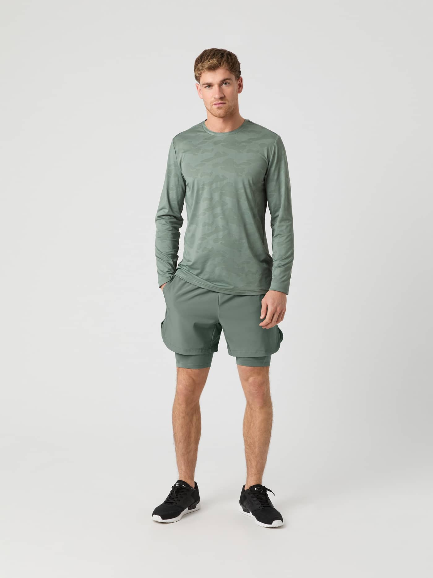 Front view of a model in Agave Green (Green) Borg 2 In 1 Shorts, combining style and function for training. - Image 3