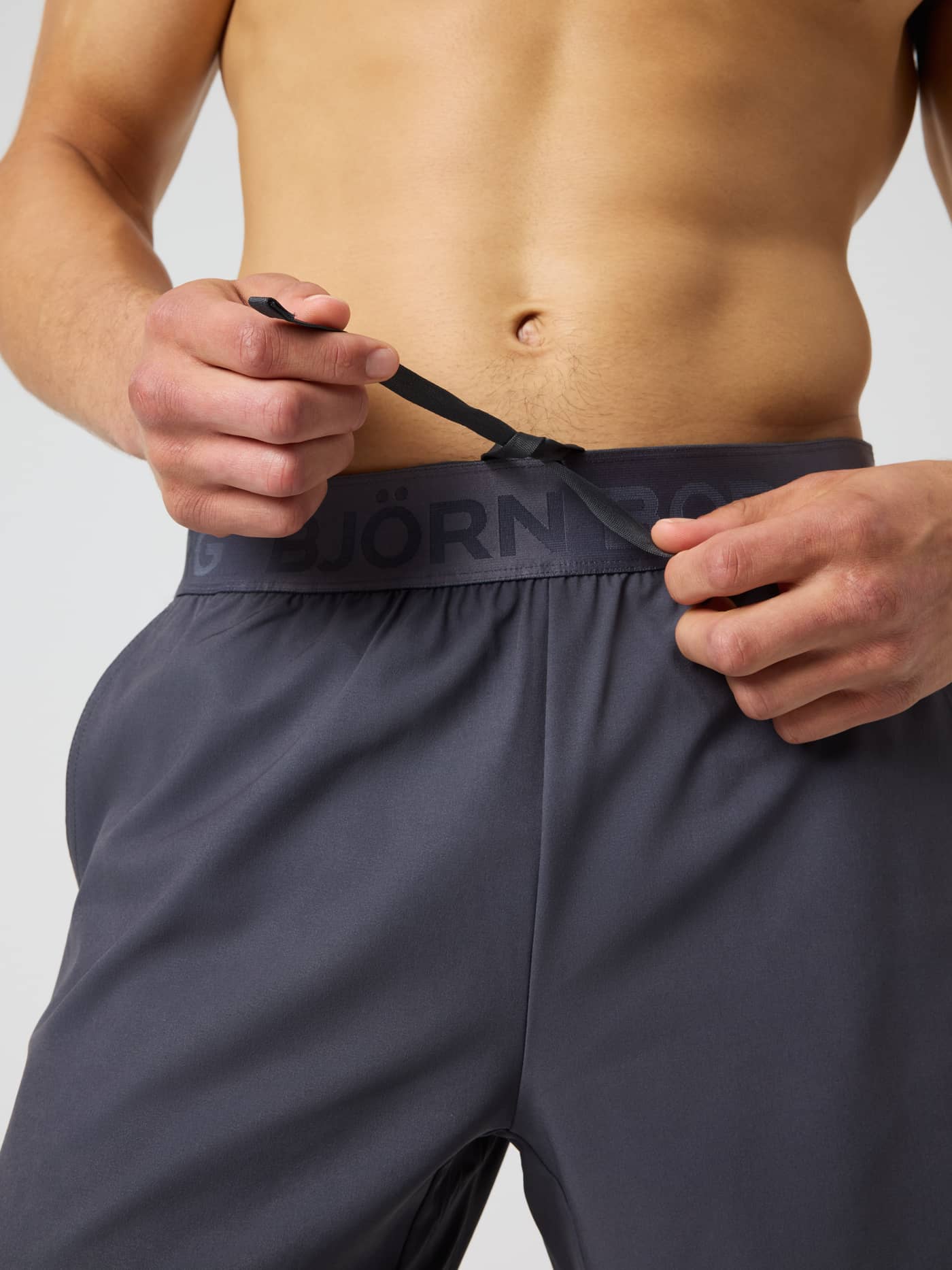 Close-up of Borg 2 In 1 Shorts in Asphalt (Grey) featuring a tonal logo waistband and drawstring for technical training. - Image 5