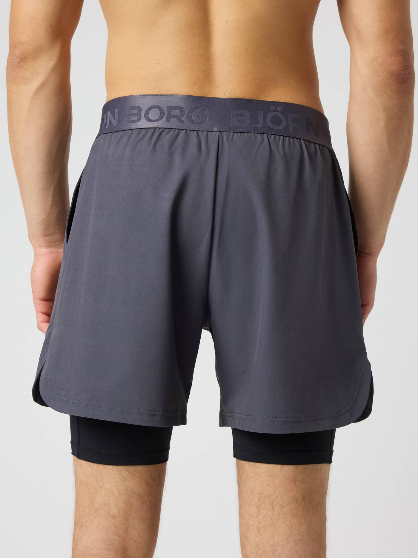 Back view of the Borg 2 In 1 Shorts in Asphalt (Grey) with a branded waistband and inner layer for training and tennis. - Image 2