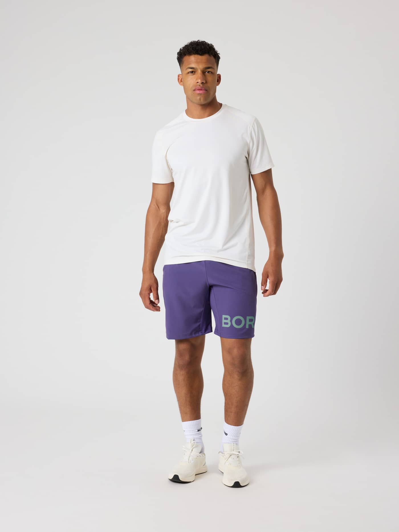 Full-body front view of a man wearing the breathable, moisture-wicking Borg Athletic T-Shirt in Tofu (White) for training. - Image 3