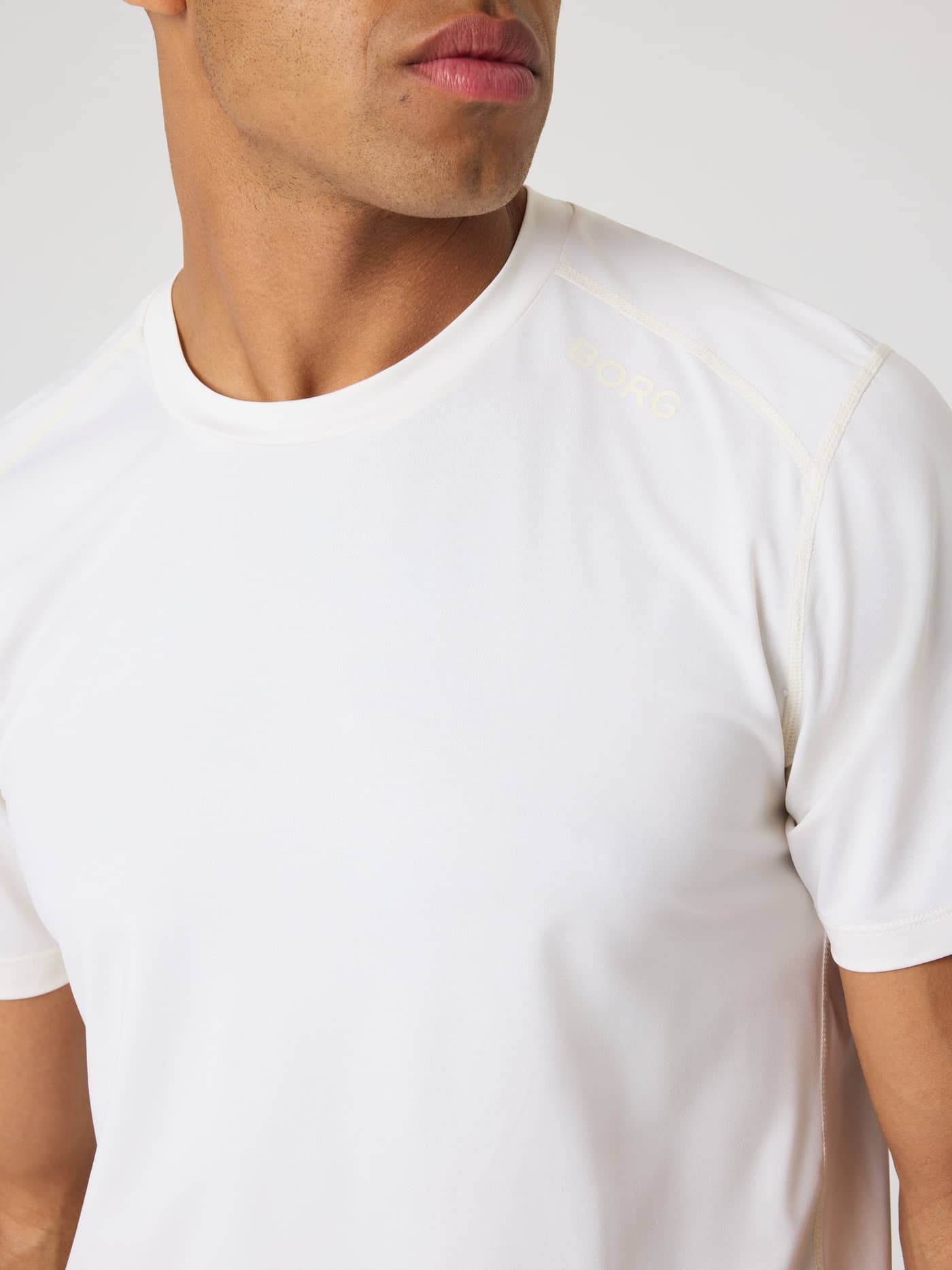 Close-up of the breathable training Borg Athletic T-Shirt in Tofu (White) with a matching BORG logo on the shoulder. - Image 4