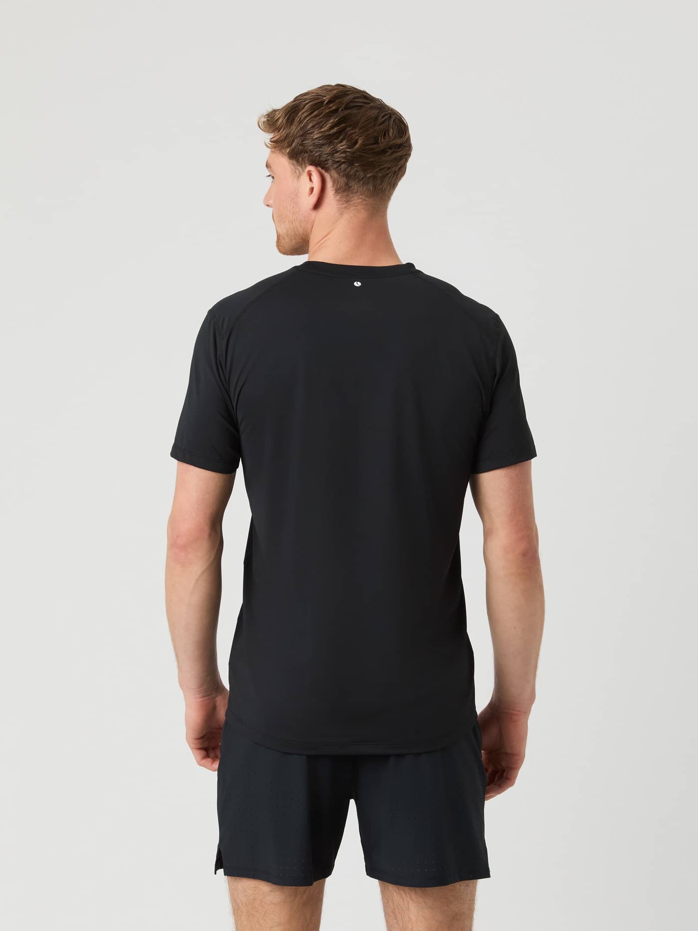 Back view of a male model wearing the black Borg Athletic T-shirt. - Image 2