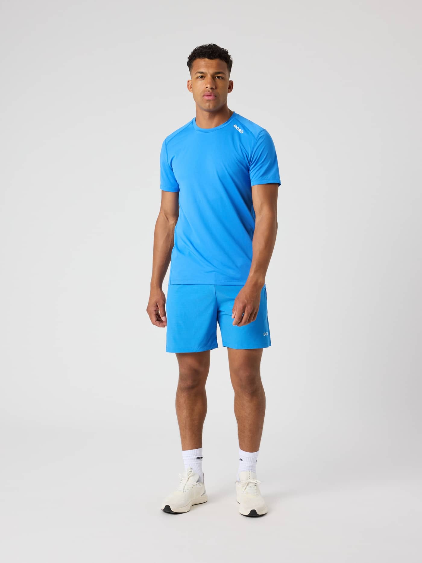 Full-body front view of a man wearing the Björn Borg Athletic T-Shirt in Palace Blue (Blue) for functional training style. - Image 3