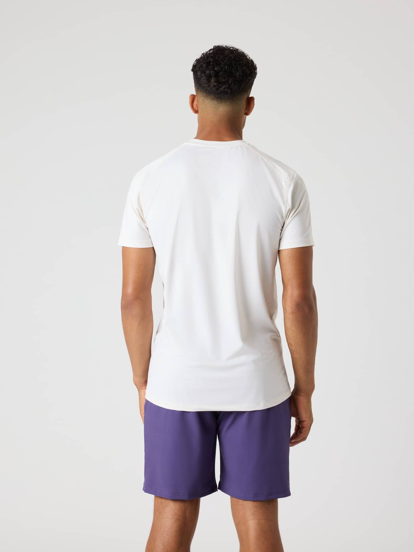 Back view of a man wearing the Björn Borg Athletic T-Shirt in Tofu (White) for training. - Image 2