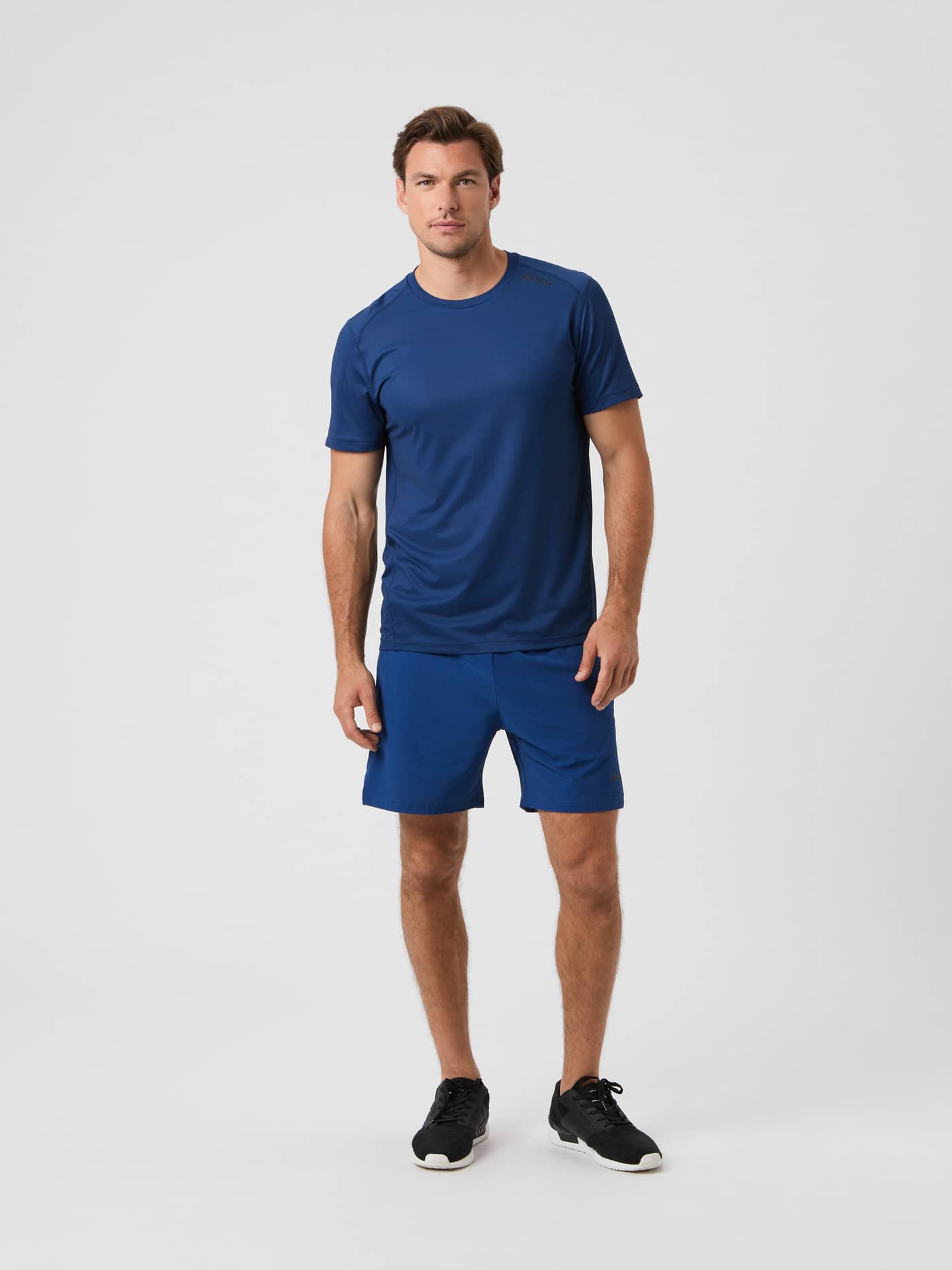 Front view of a model wearing the Borg Athletic T-shirt in Estate Blue and matching shorts. - Image 3