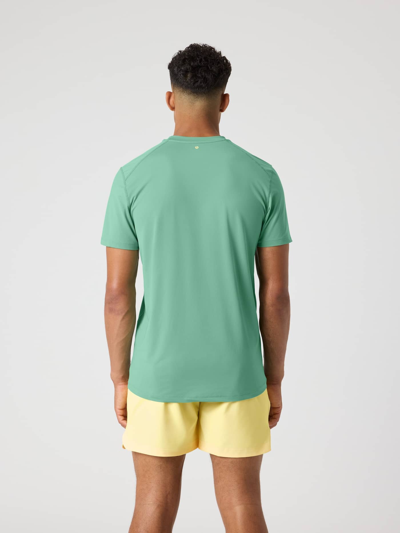 Back view of a man wearing the Malachite Green (Green) Borg Athletic T-Shirt for performance training. - Image 2