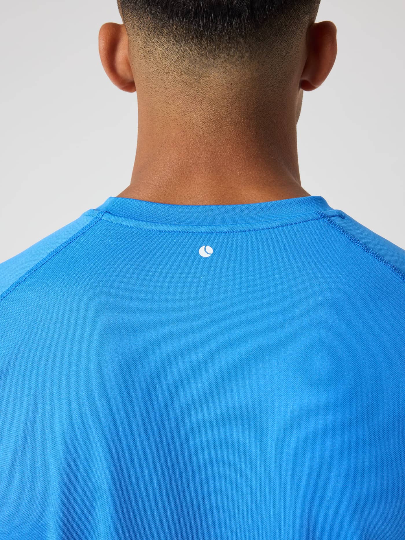 Detailed back view of the Palace Blue (Blue) Borg Athletic T-Shirt, showcasing the tennis ball print at the neck. - Image 4