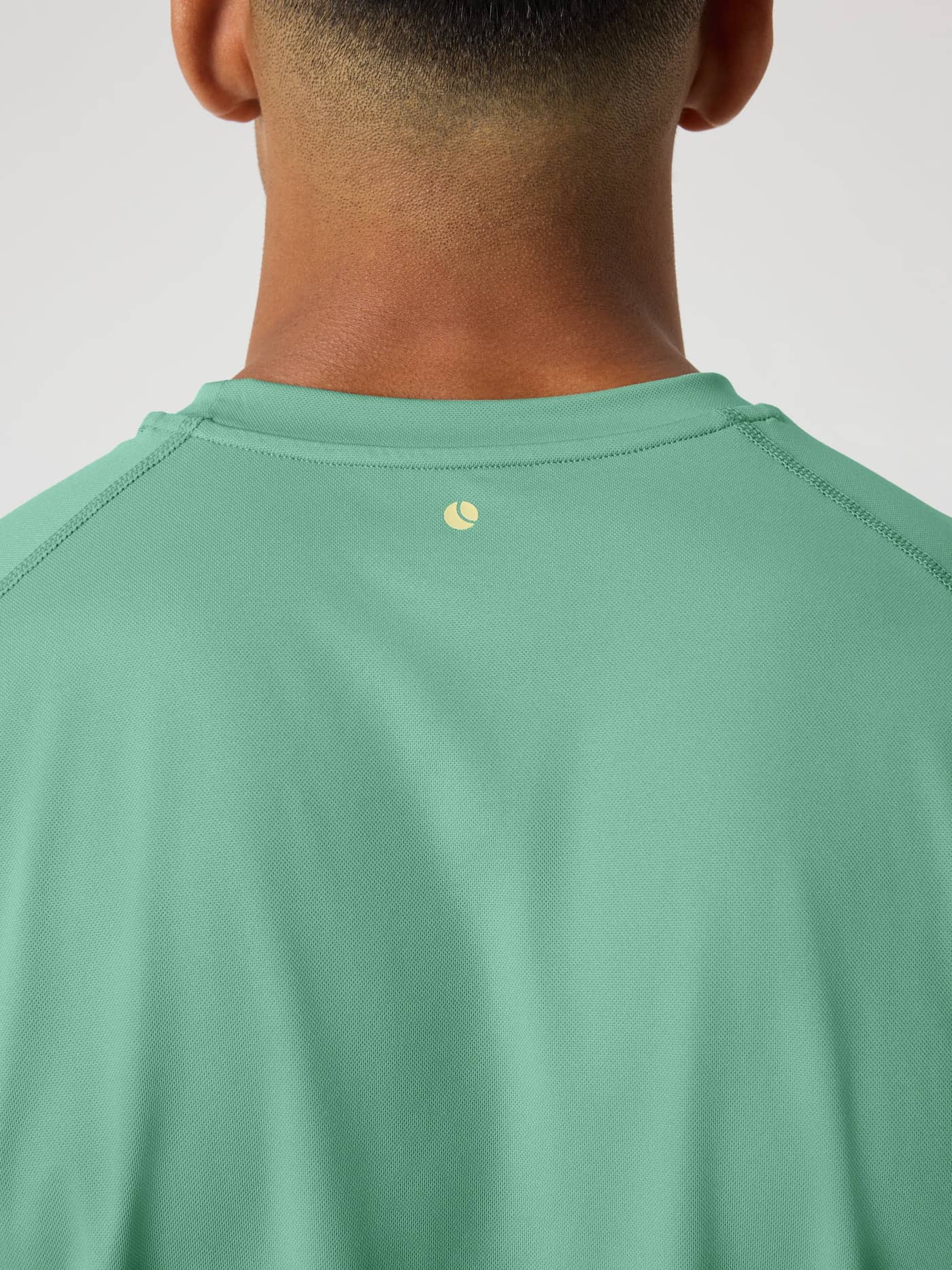 Back view of the Malachite Green (Green) Borg Athletic T-Shirt with a yellow tennis ball logo for performance training. - Image 4