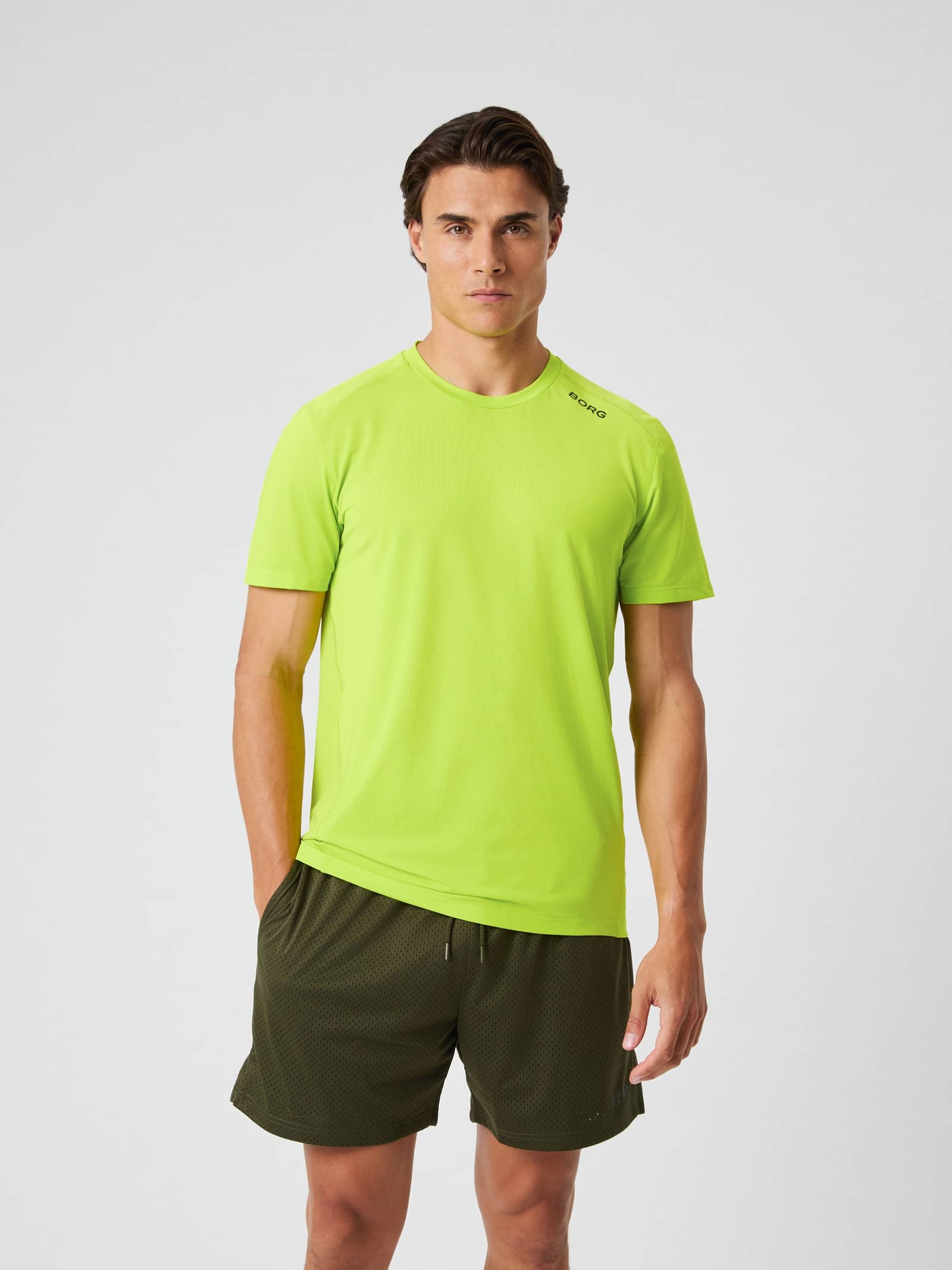 Front view of a man wearing the Borg Athletic T-Shirt in Acid Lime. - Image 1