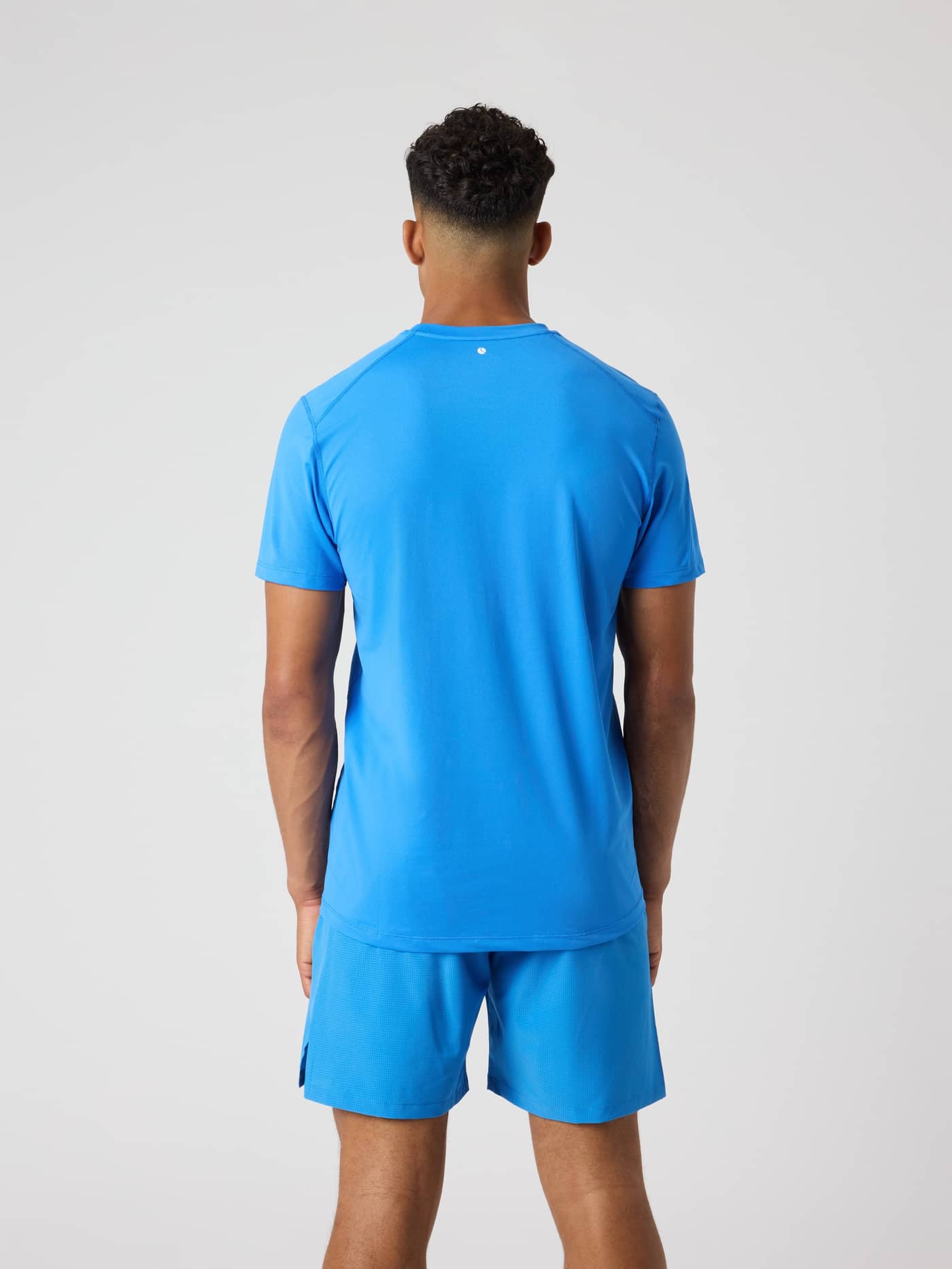 Back view of a man wearing the Björn Borg Athletic T-Shirt in Palace Blue (Blue), a functional performance training top. - Image 2