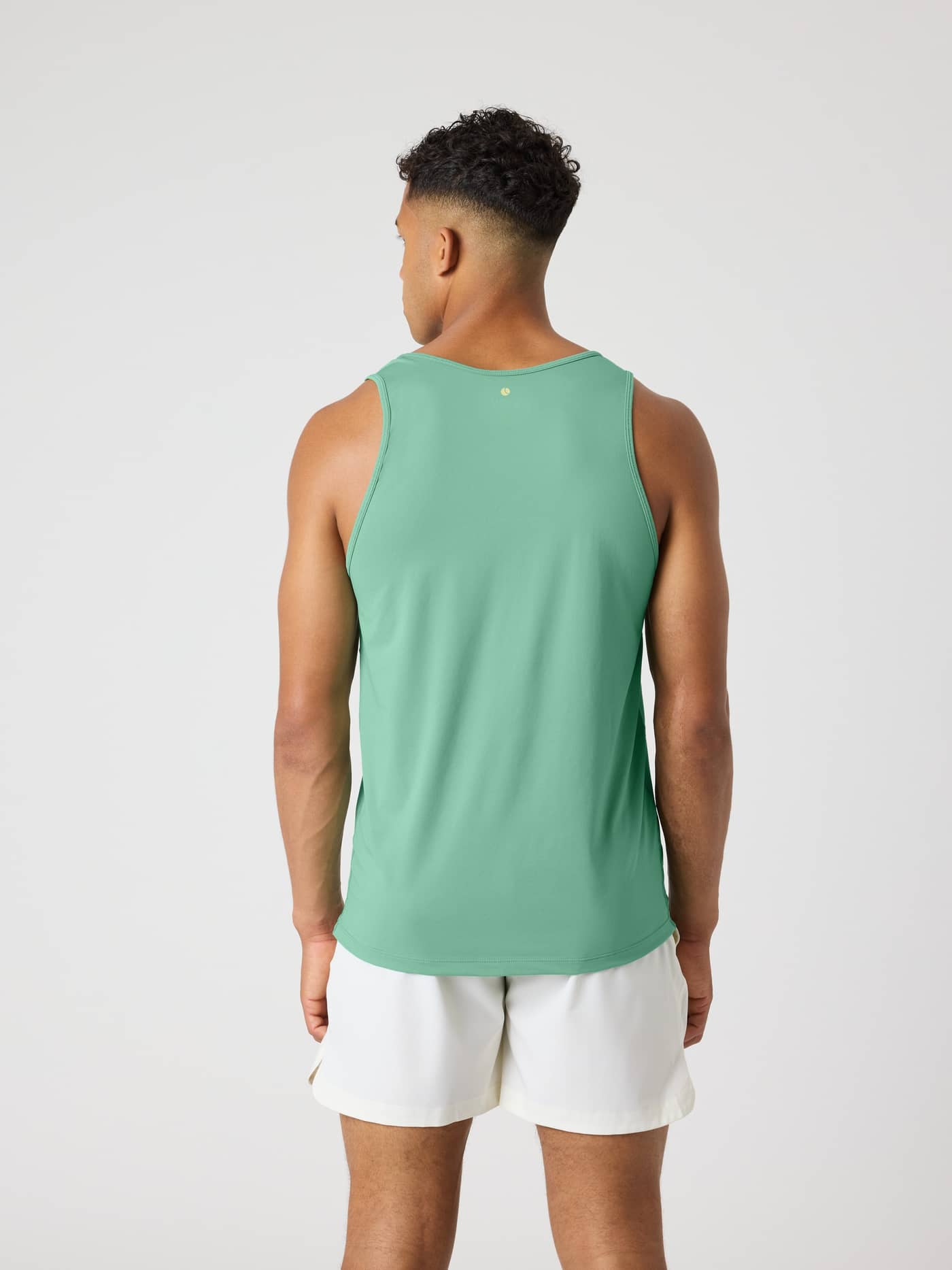 Back view of a model wearing the Malachite Green (Green) Borg Athletic Tank, optimized for tennis and training performance. - Image 2
