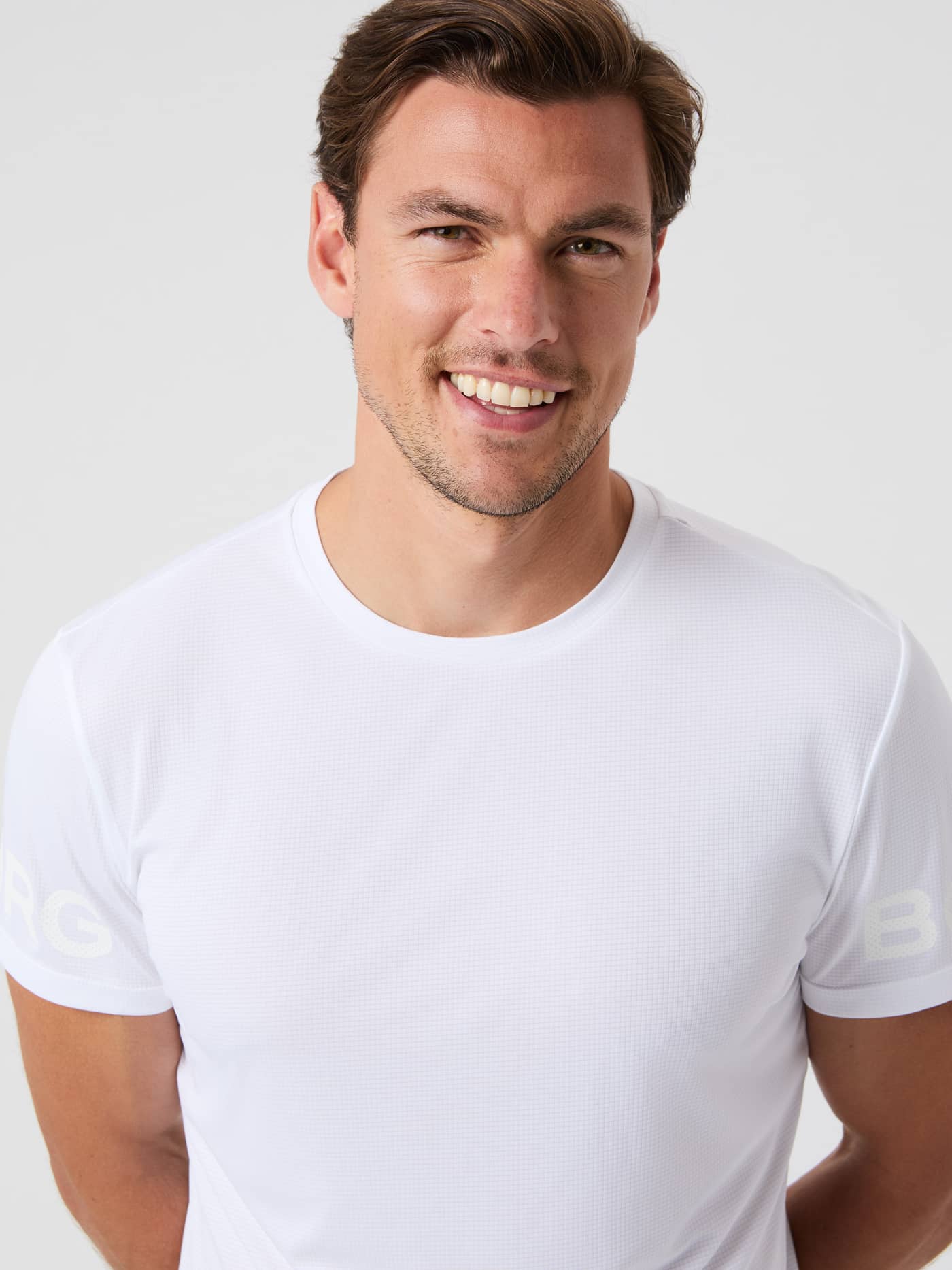 Front close-up of a man wearing the lightweight Björn Borg Light T-Shirt in Brilliant White (White) for training. - Image 6
