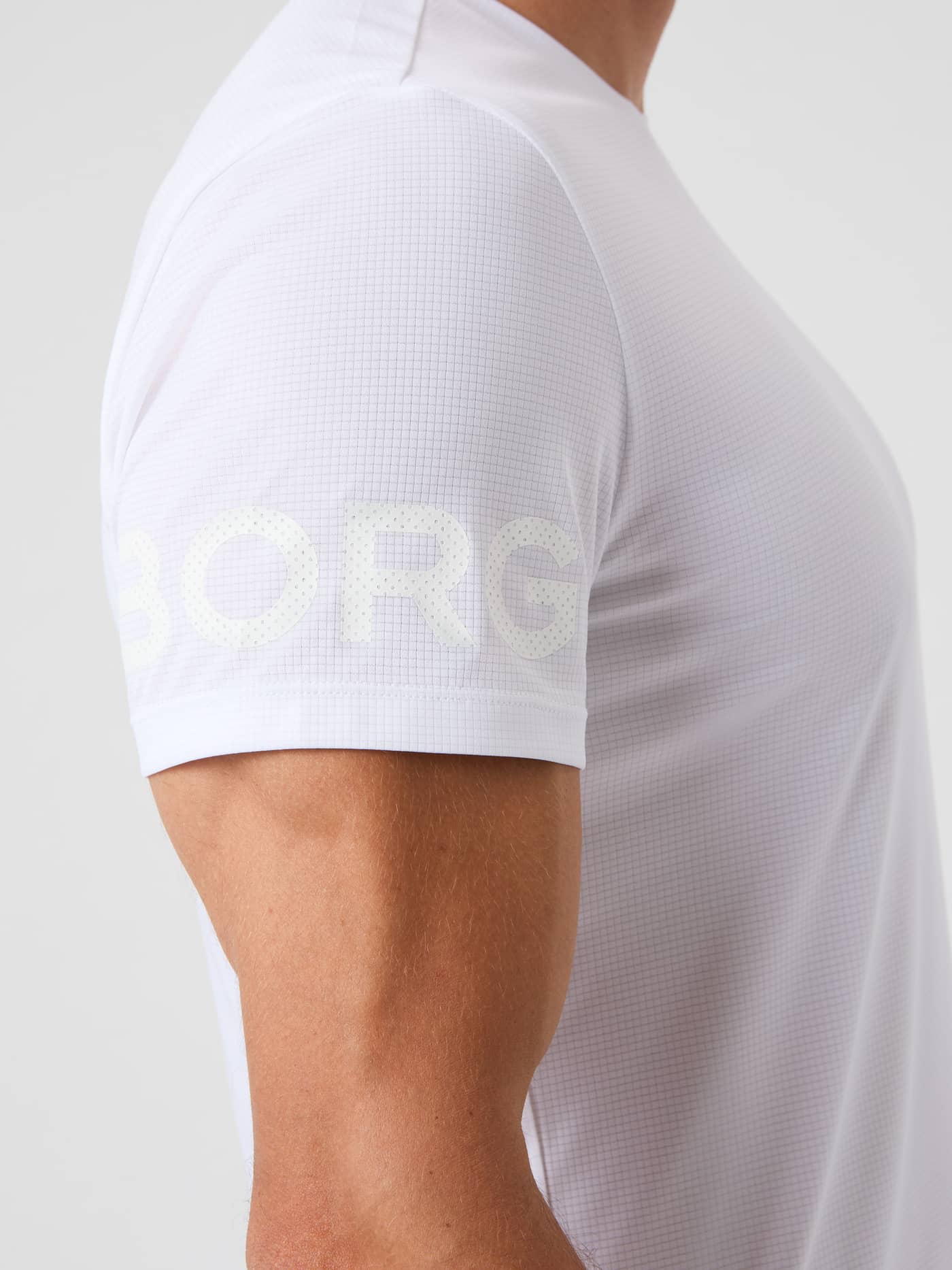 Side view of the men's training Borg Light T-Shirt in Brilliant White (White), with structured jersey and sleeve logo. - Image 5