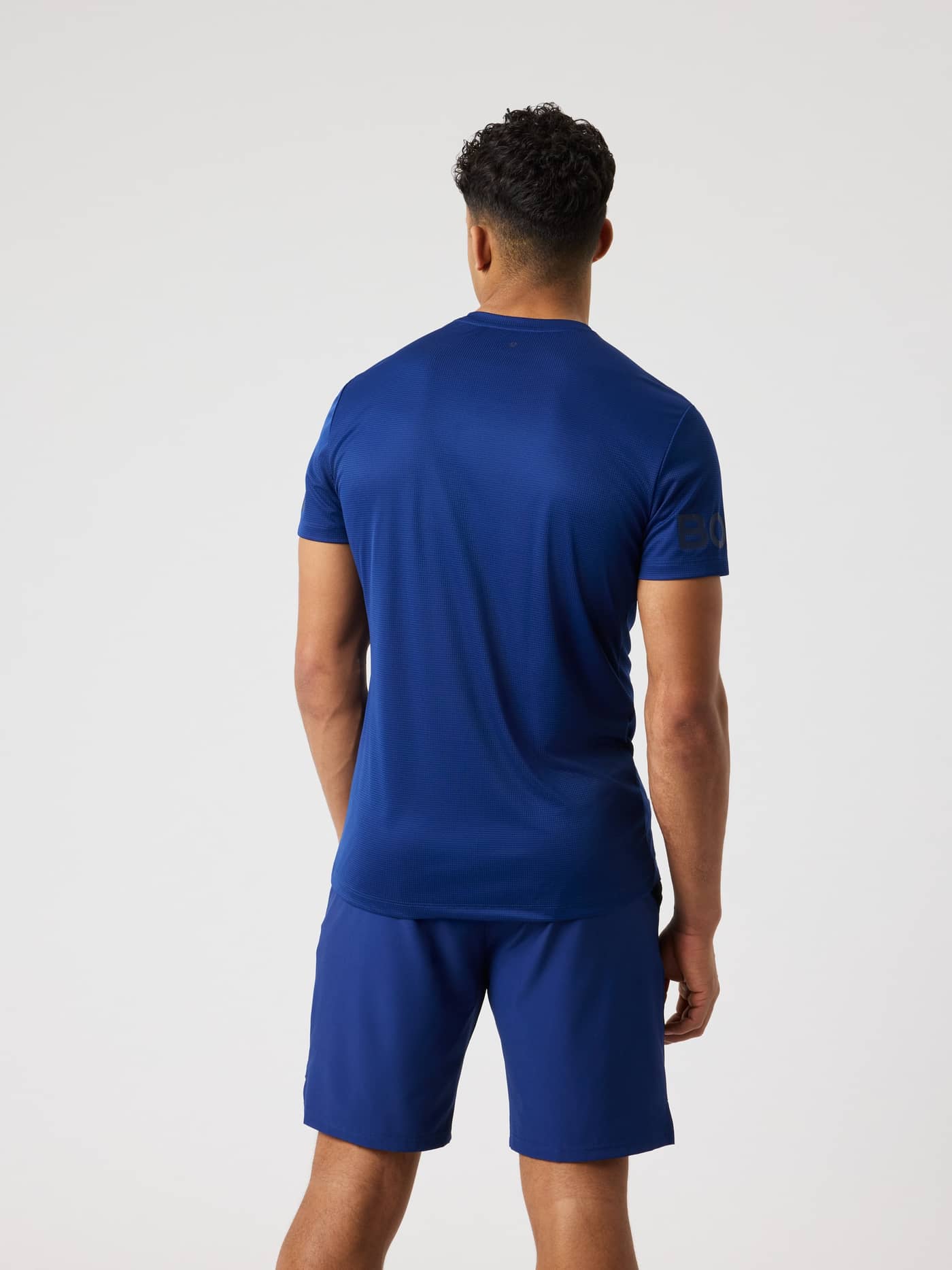 Vista posterior de la Borg Light T-Shirt en Blue Depths (Azul) para entrenamiento, tenis y running con logos negros. - Image 2