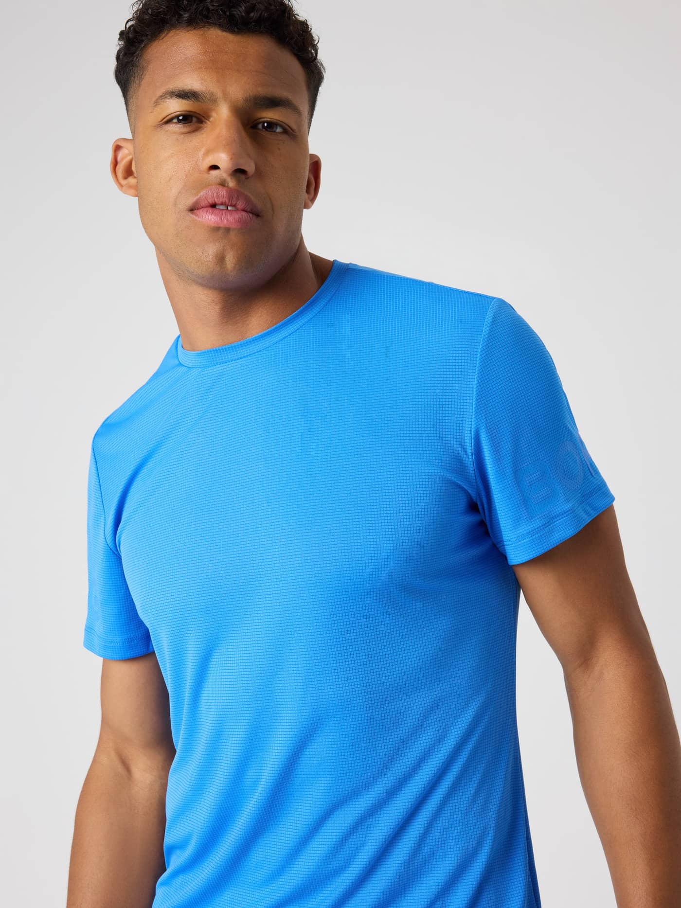 Front view of a model wearing the Borg Light T-Shirt in Palace Blue (Blue), a functional training tee. - Image 5