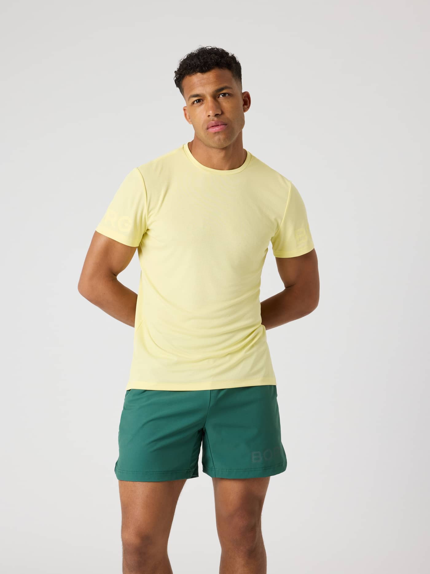 Vooraanzicht van een man in het Borg Light T-Shirt in Lemonade (Geel), een functioneel trainingsshirt met tonale mouwlogo's. - Image 1
